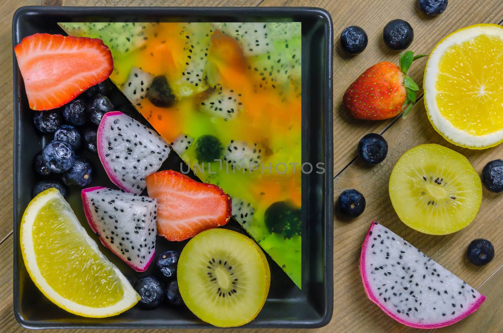 Top view of mixed jelly fruits ( strawberry, blueberry, kiwi, orange, dragon fruit )
