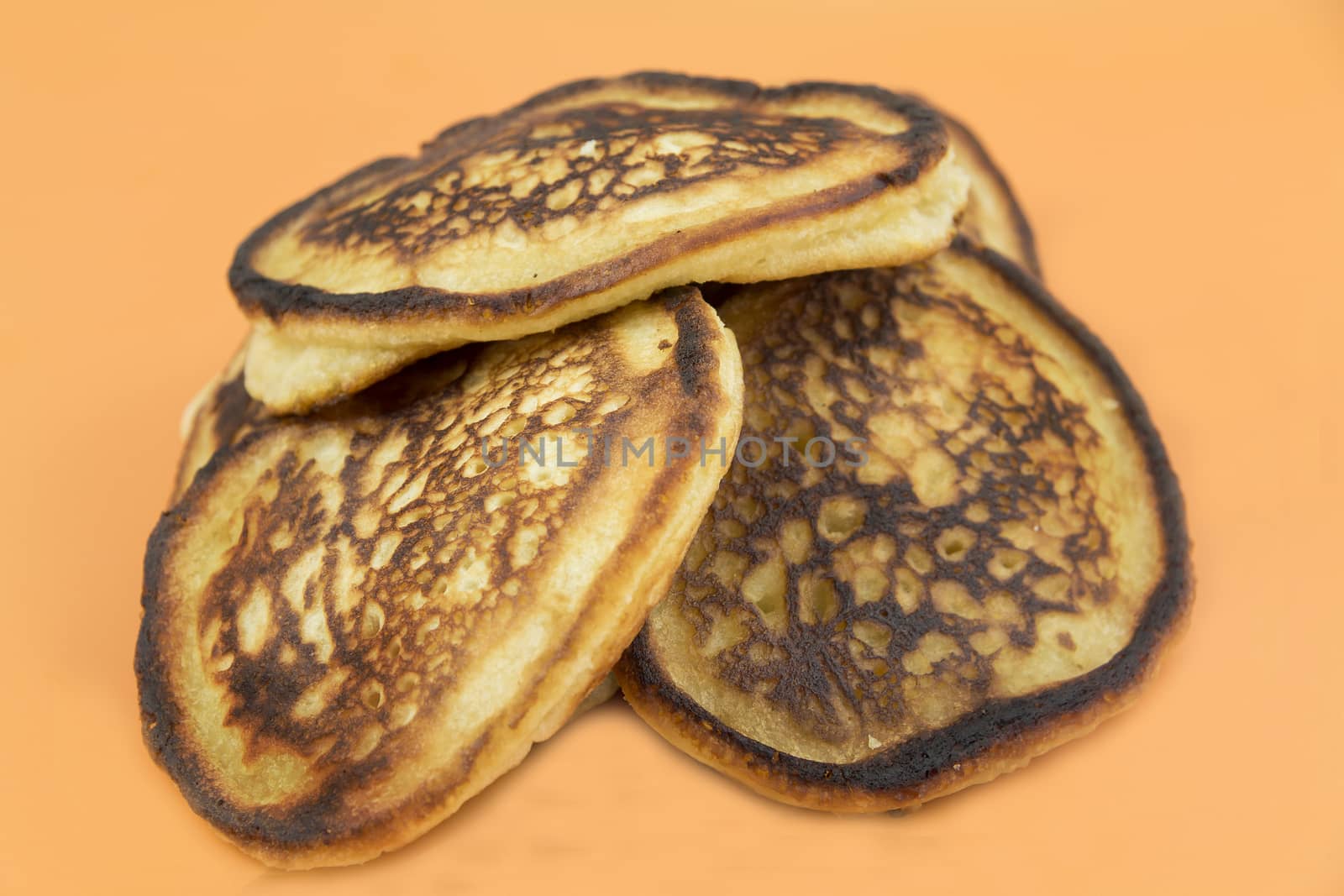 Closeup of lush fresh pancakes on a yellow background