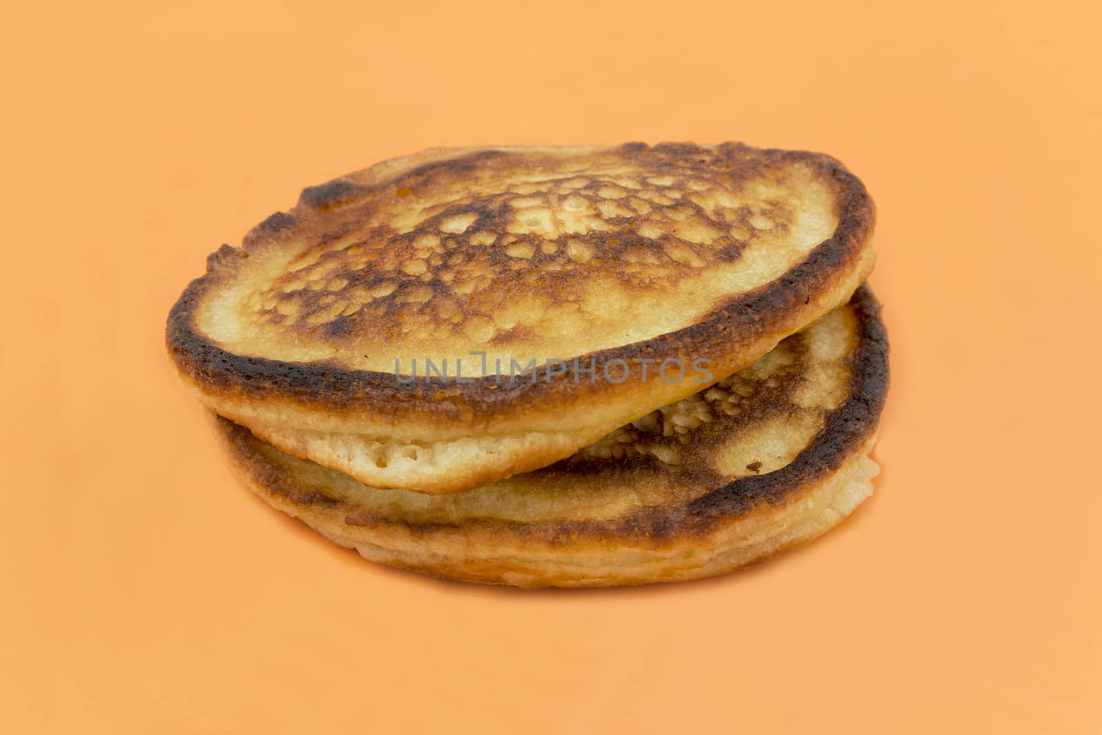 Close-up of two lush thick muffin on a yellow background