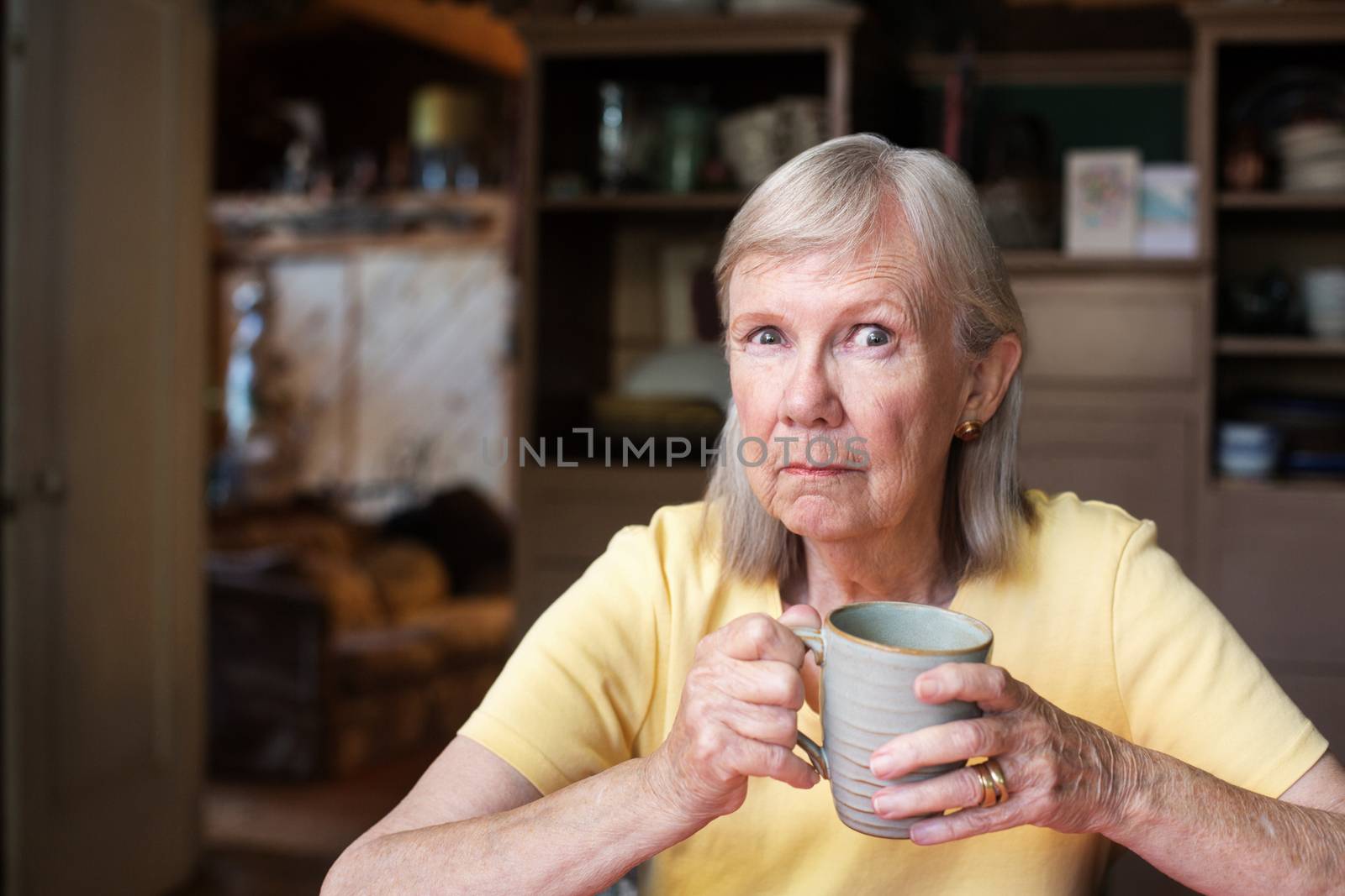 Angry mature woman holding cup by Creatista