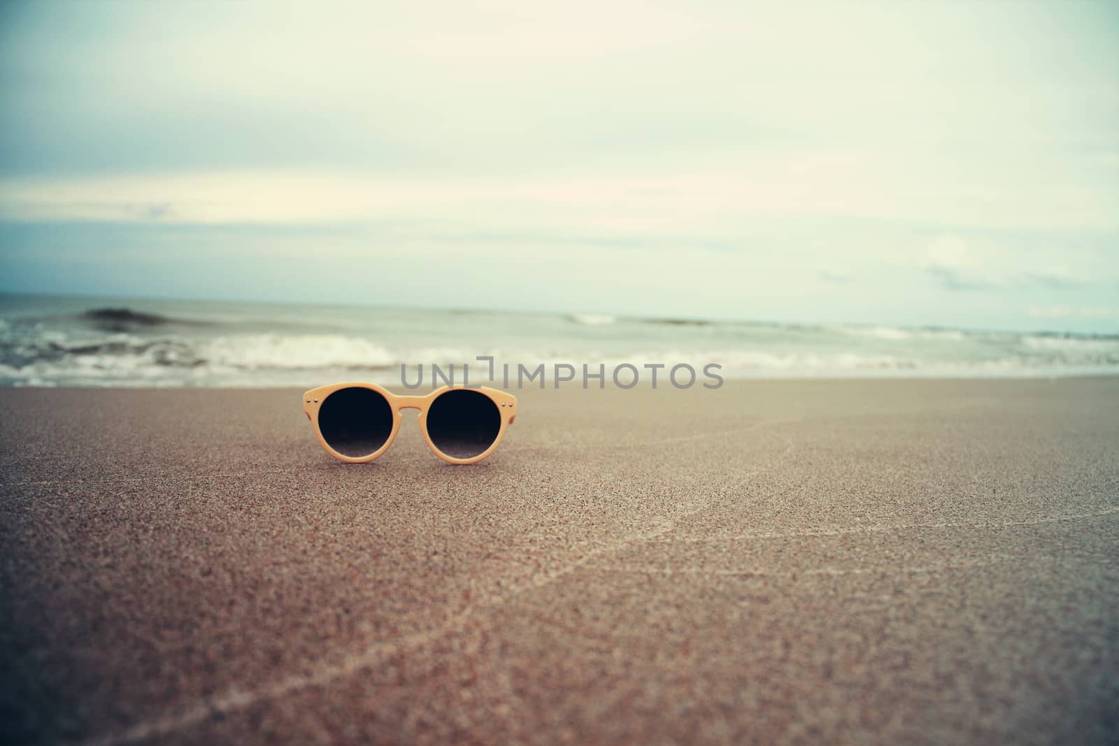 Sunglasses on the sand  beach by Voinakh