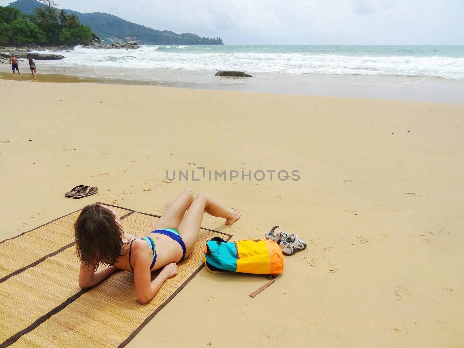 beautifull woman in bikini lying on tropical beach in Thailand by evolutionnow