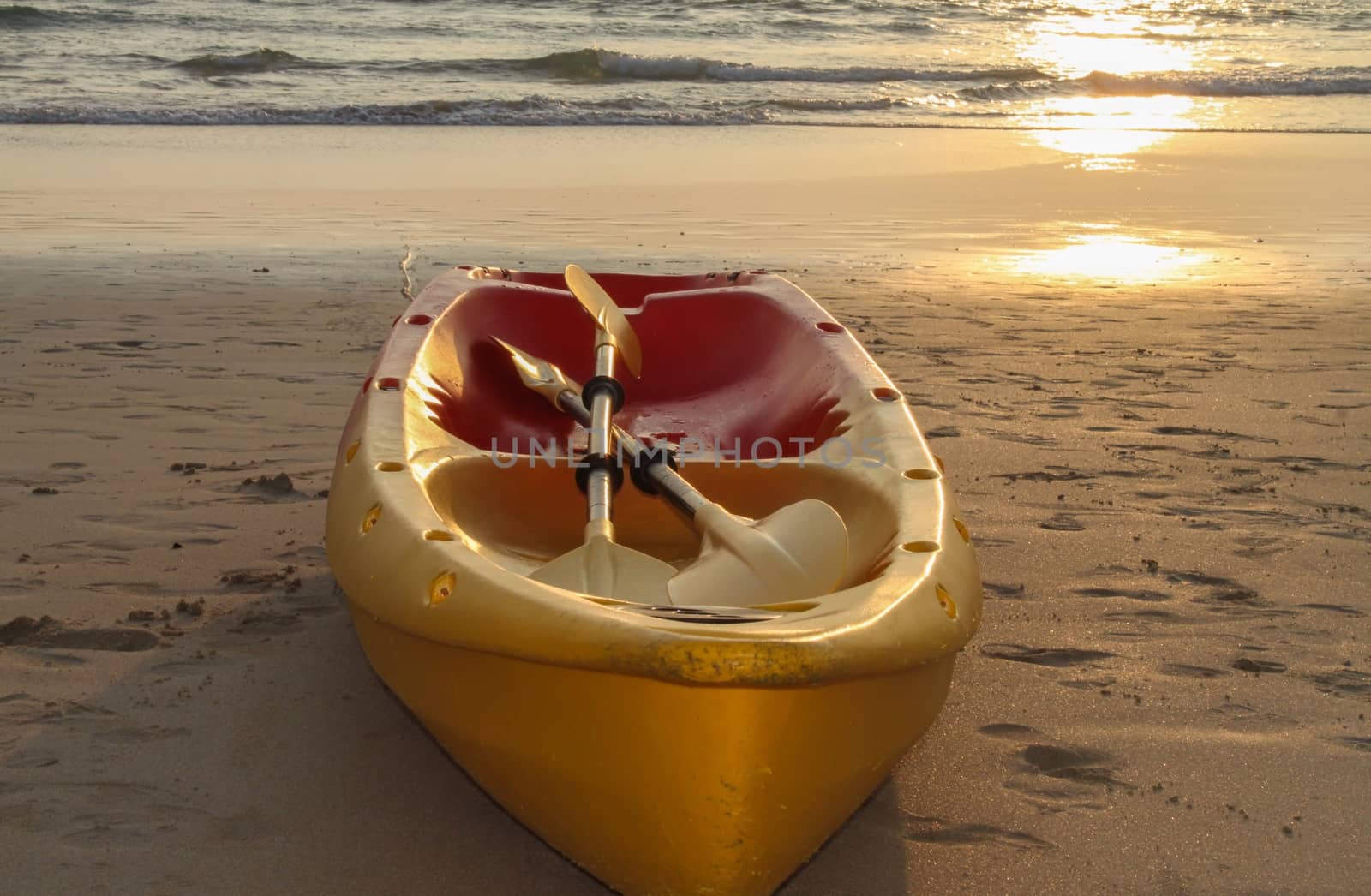 Kayaks canoe boat on the beach during sunset by evolutionnow