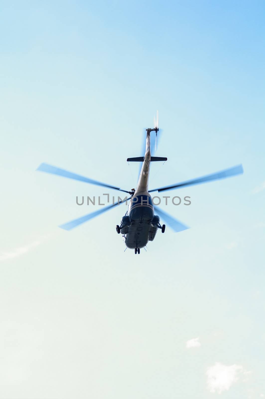 a Helicopter flying against the blue sky