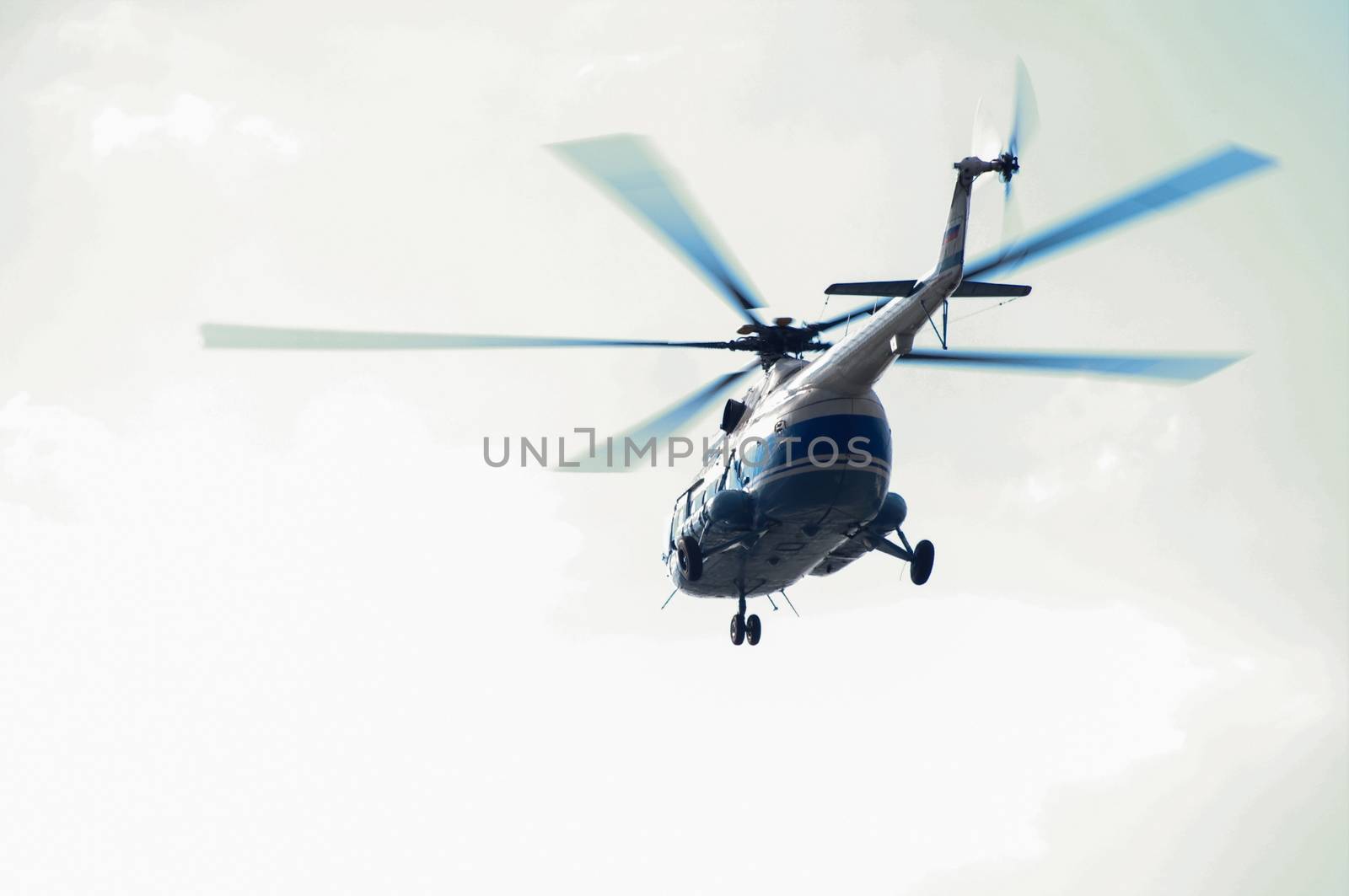 a Helicopter flying against the blue sky