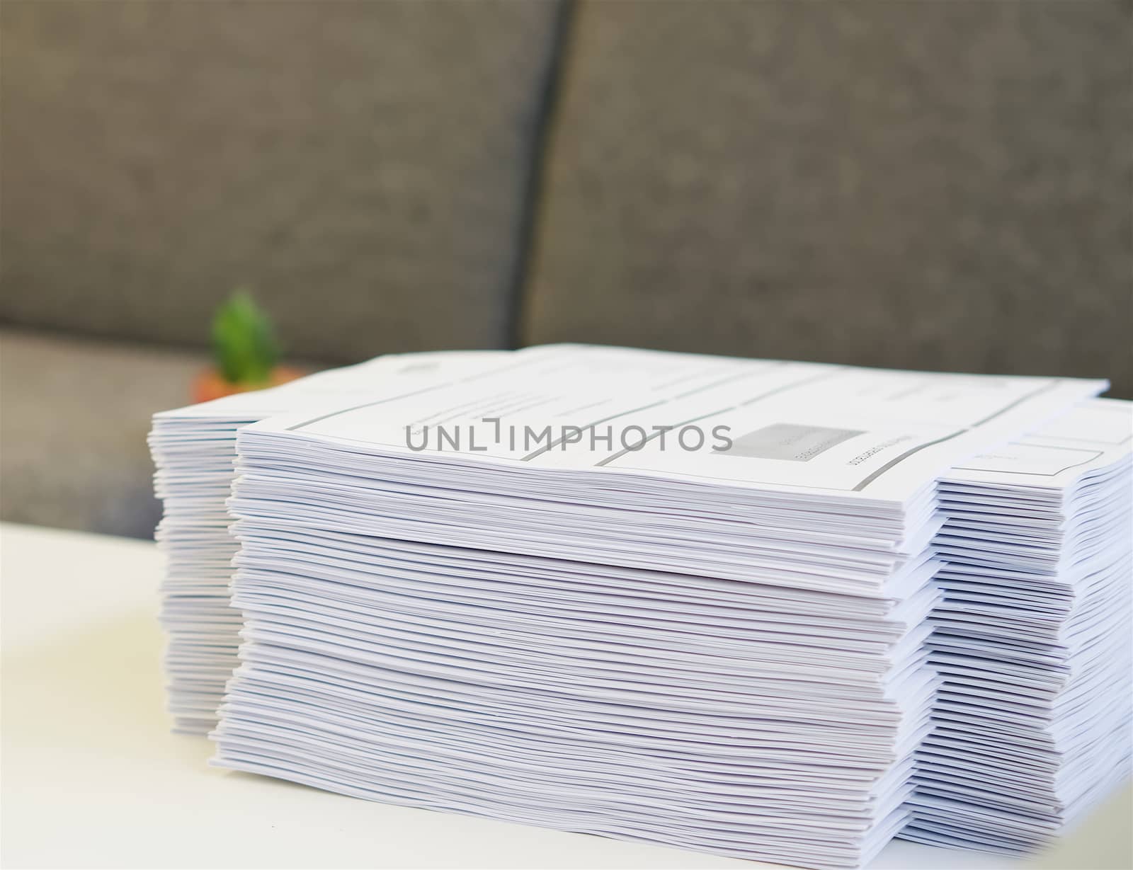 Stack of paper was put on table at office environment.