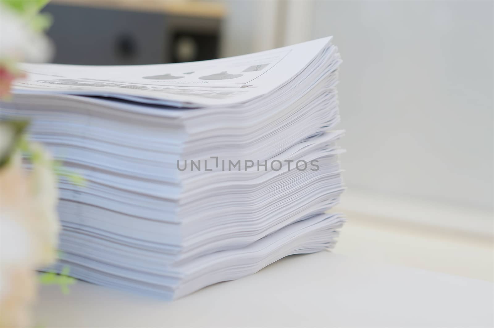 Stack of paper was put on table at office environment.                              