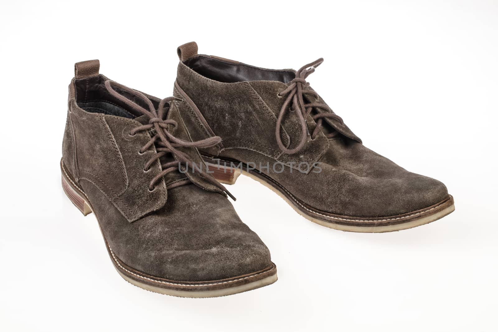 Pair of suede shoes on an isolated studio background