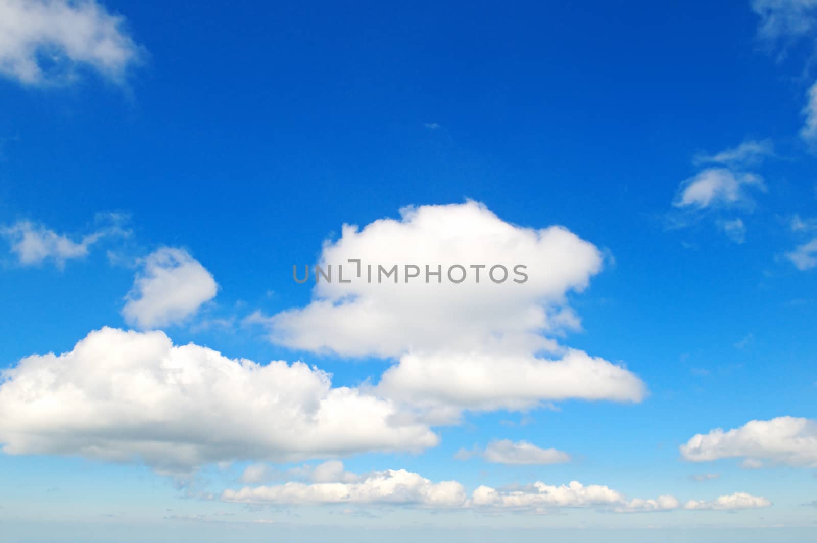 fluffy clouds in the blue sky