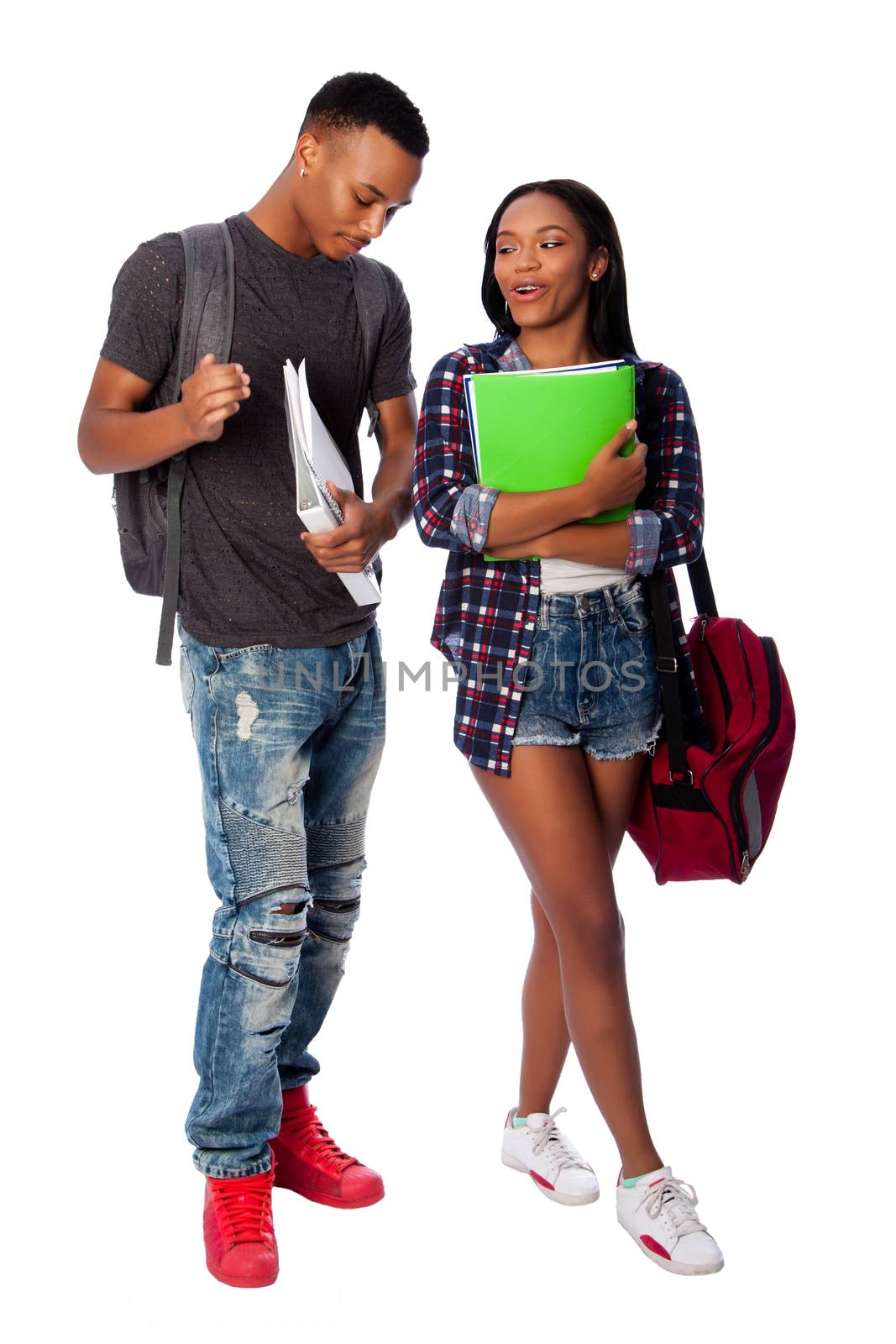 Happy smiling students standing together having fun talking joking carrying book bag backpack notepads, on white.