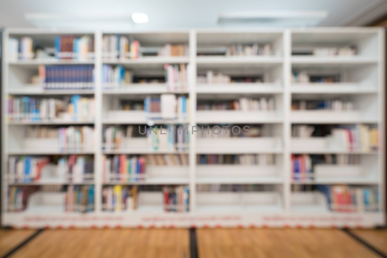 Blurred background of public library, bookshelf with books, education concept by beer5020
