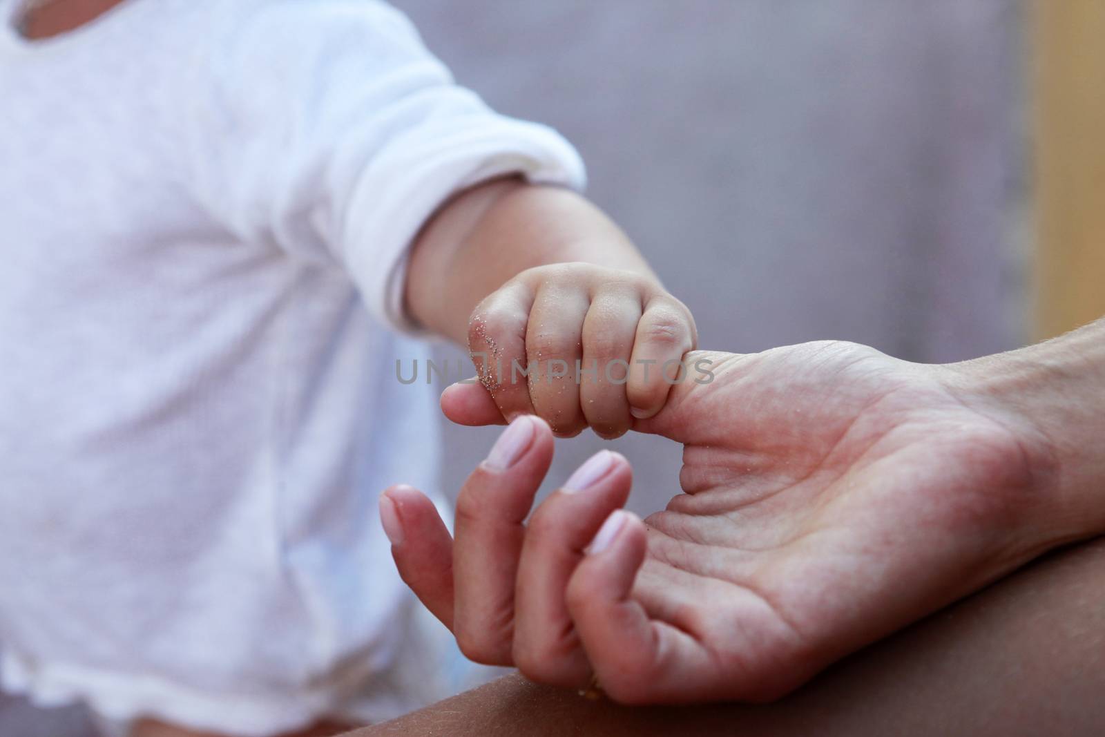 The image of hands of parents and the child