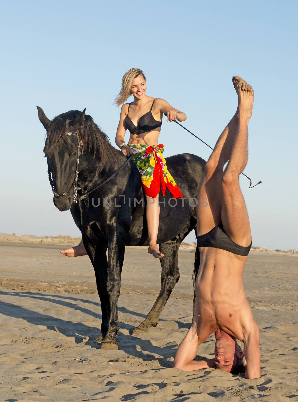 horsewoman and her horse  and yogi on the beach