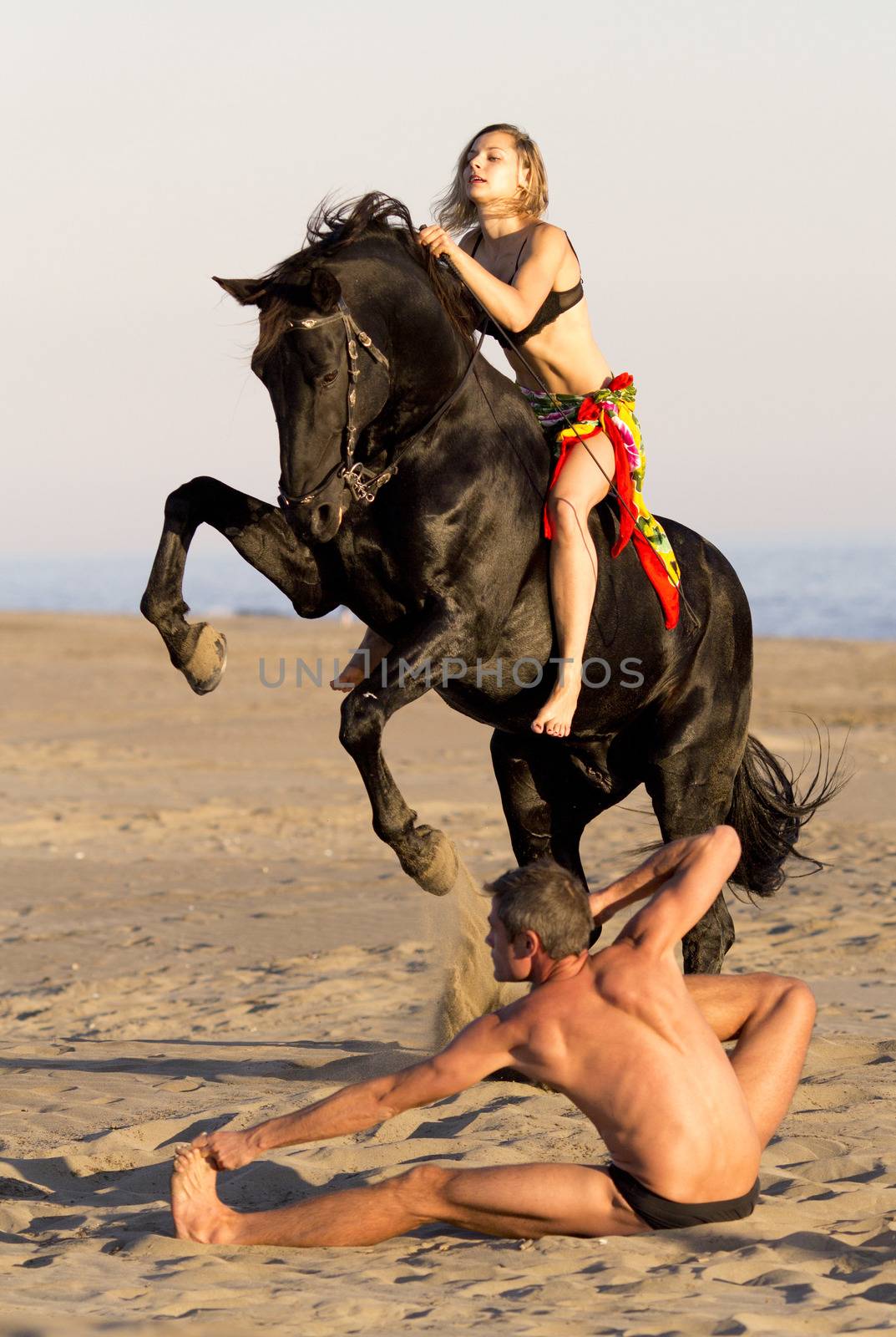 horsewoman and her horse  and yogi on the beach
