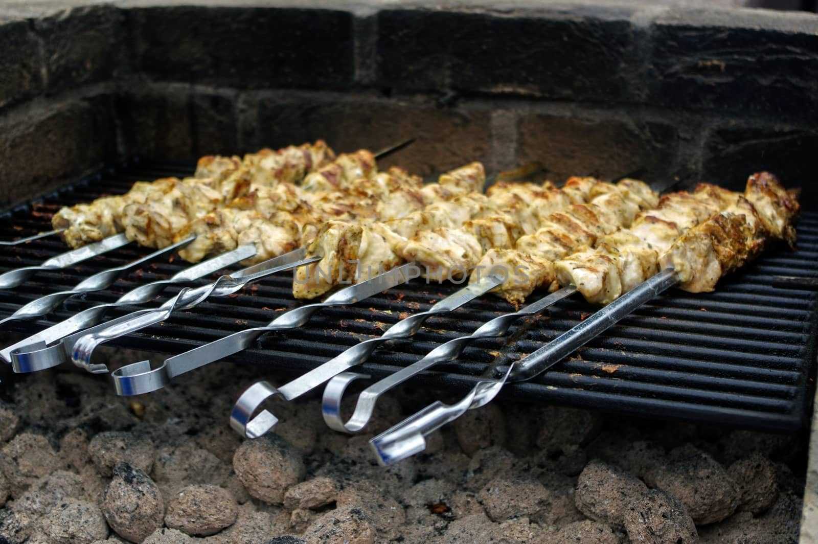 Shashlik on skewers closeup, raw and cooked by evolutionnow