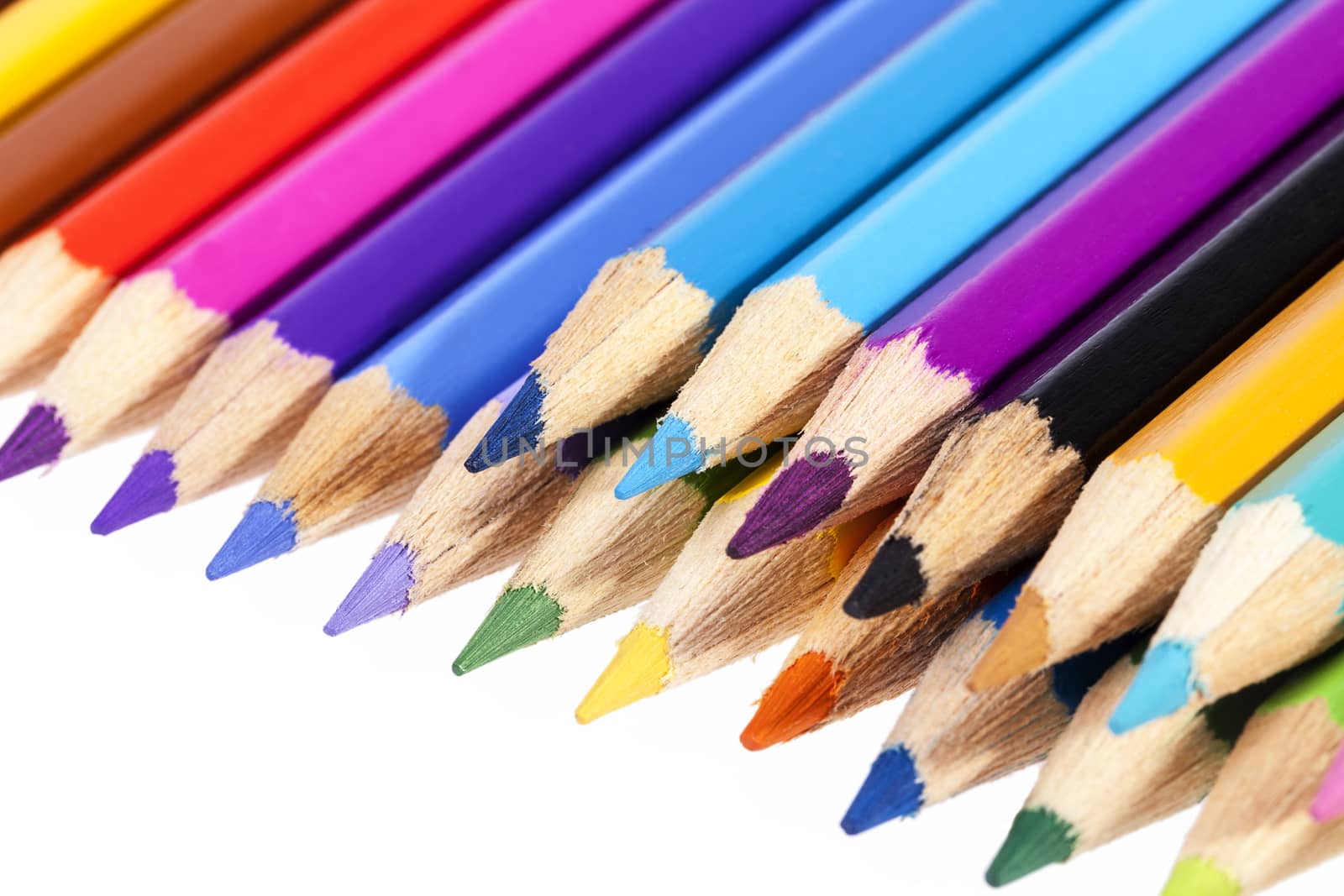 Chipped colored crayons on white background, close up by mychadre77