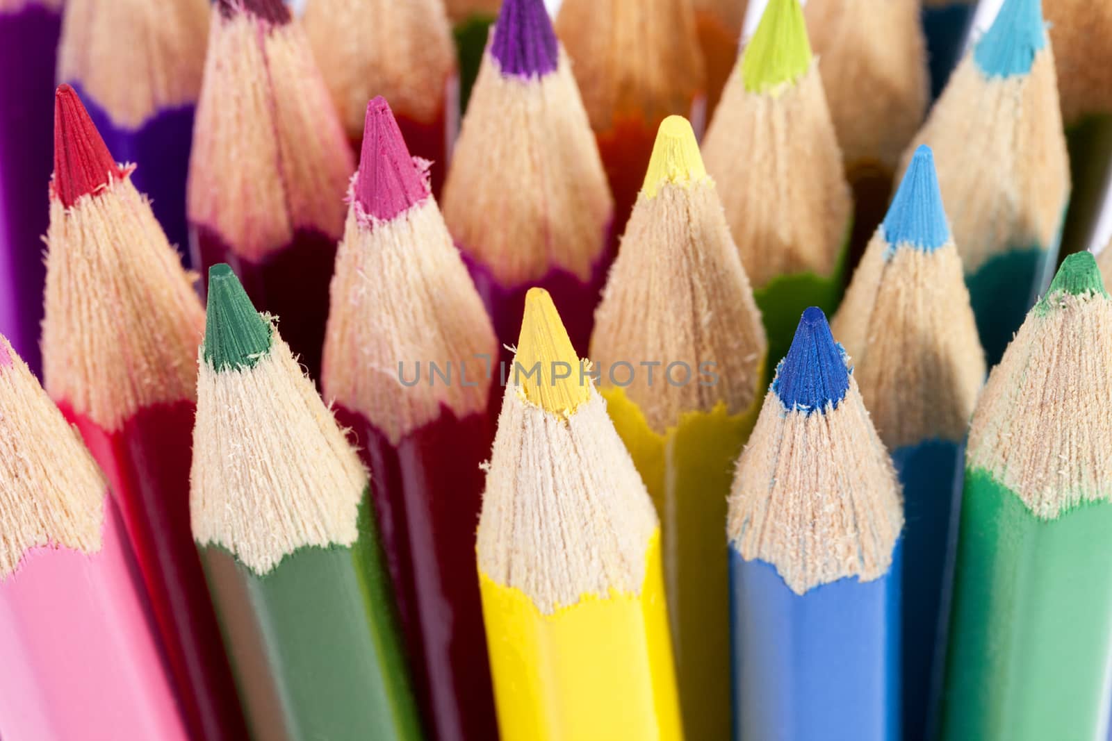 Background of chipped colored crayons on white background, close up