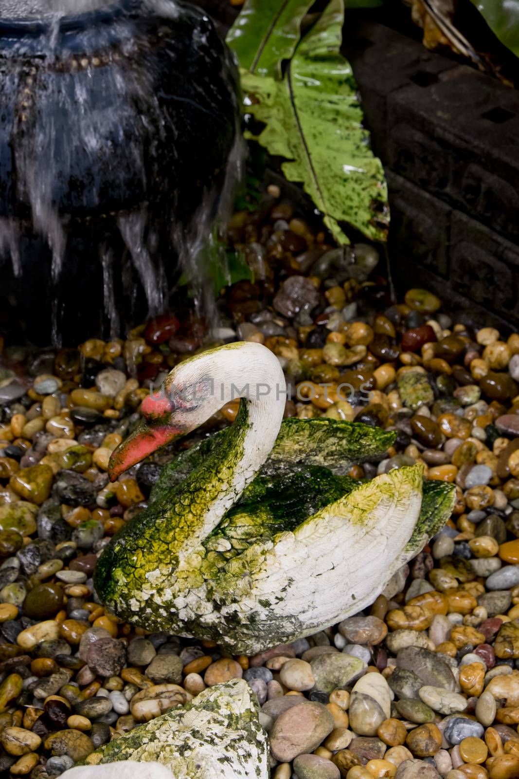 Swan statue with moss