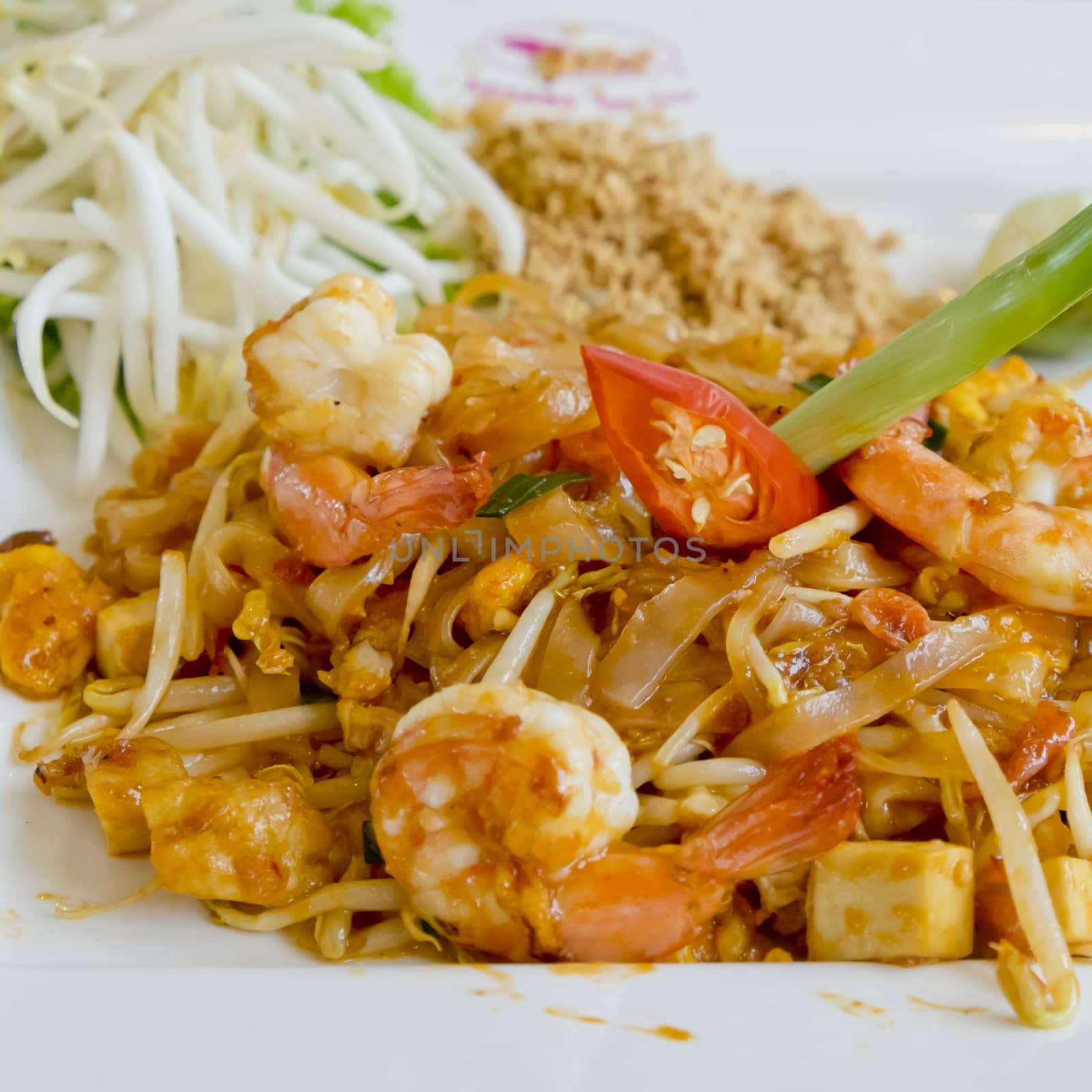 Delicious rice noodles with shrimp close-up on a plate. Thai Dish, in Thai Language we call Pad-Thai