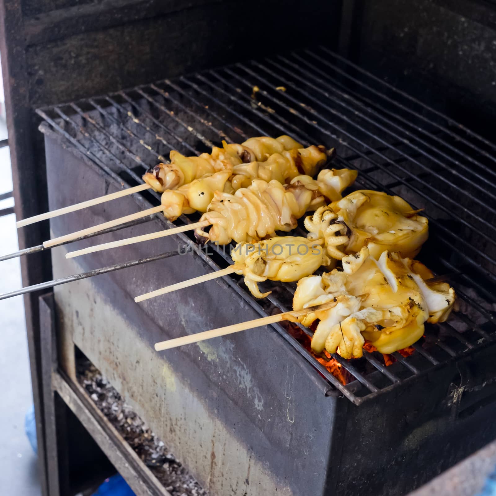 fresh squid barbeque grilled on charcoal stove