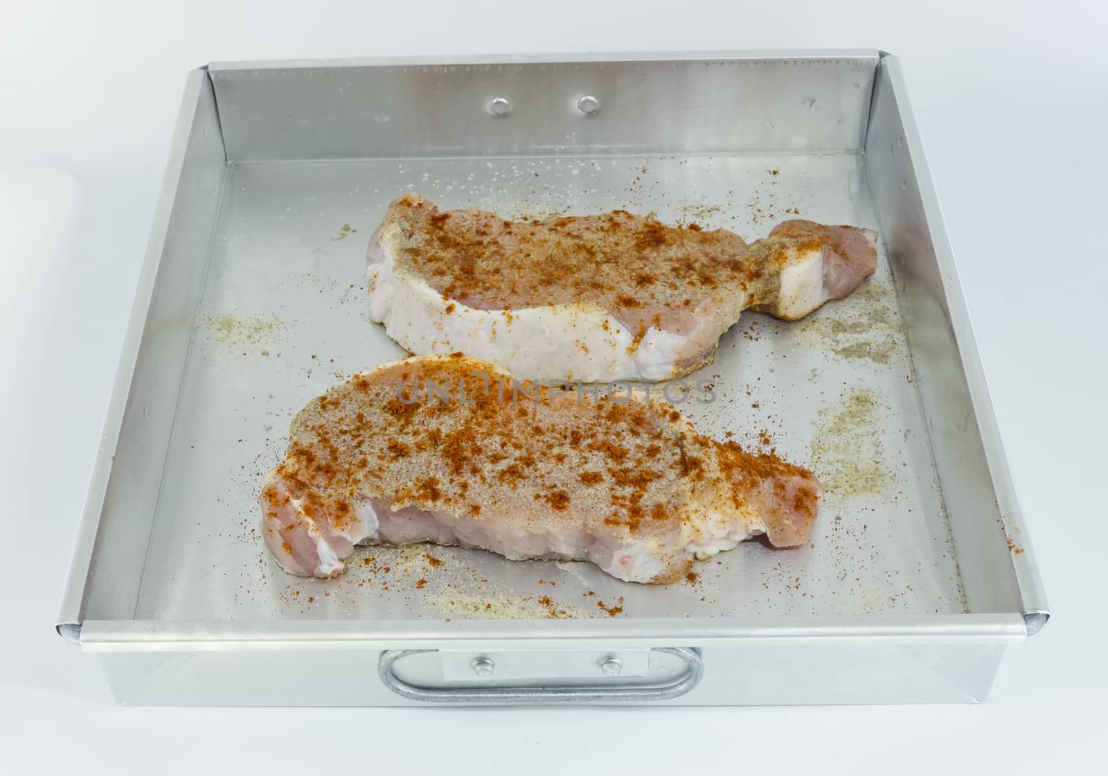Raw pork fillet with spices, Paprika, Pepper in baking tin by art9858