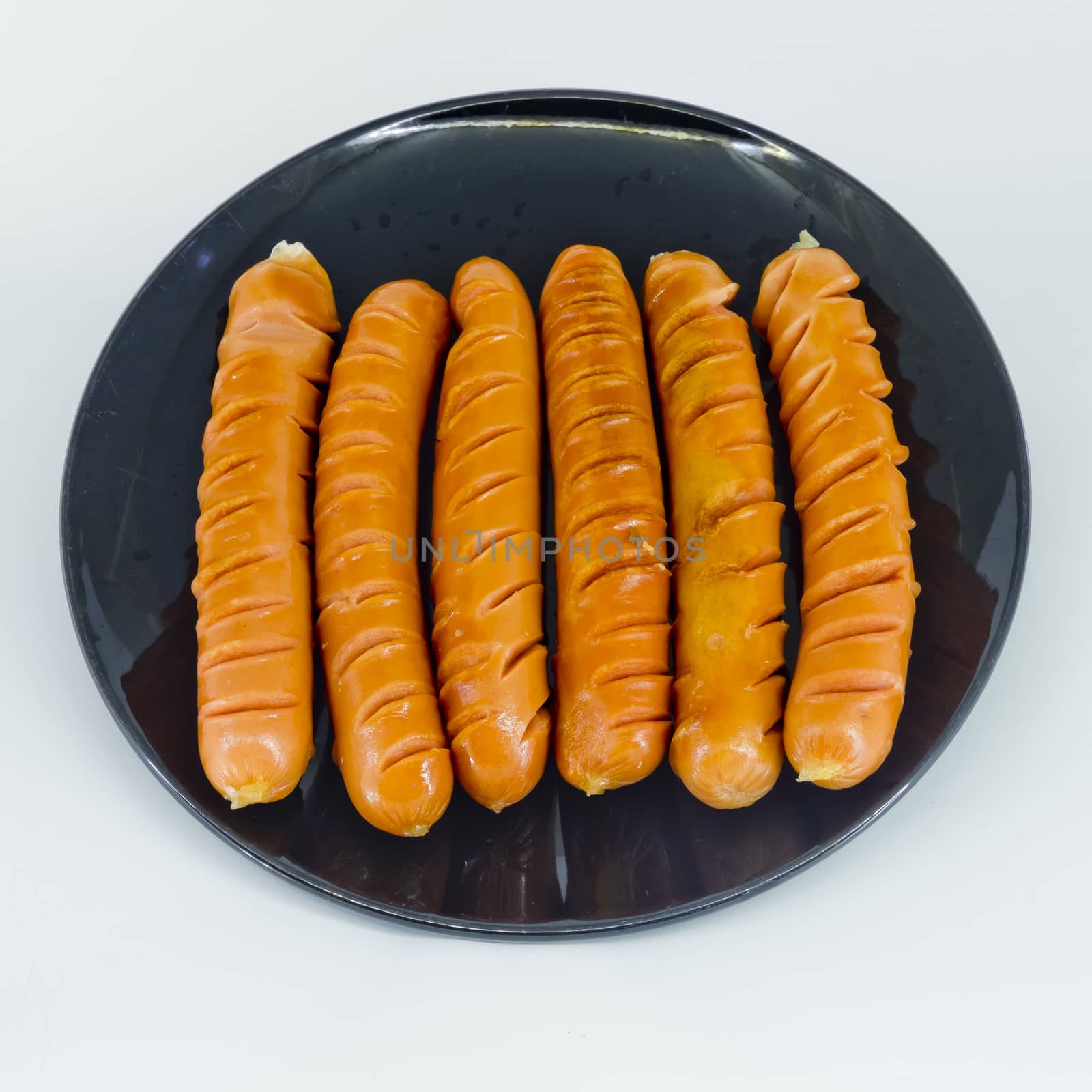 roast sausages on black dish by art9858