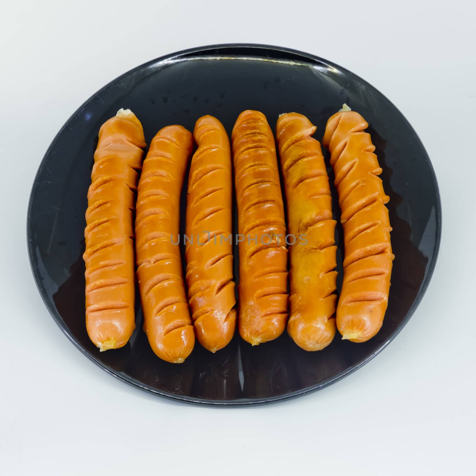 roast sausages on black dish by art9858