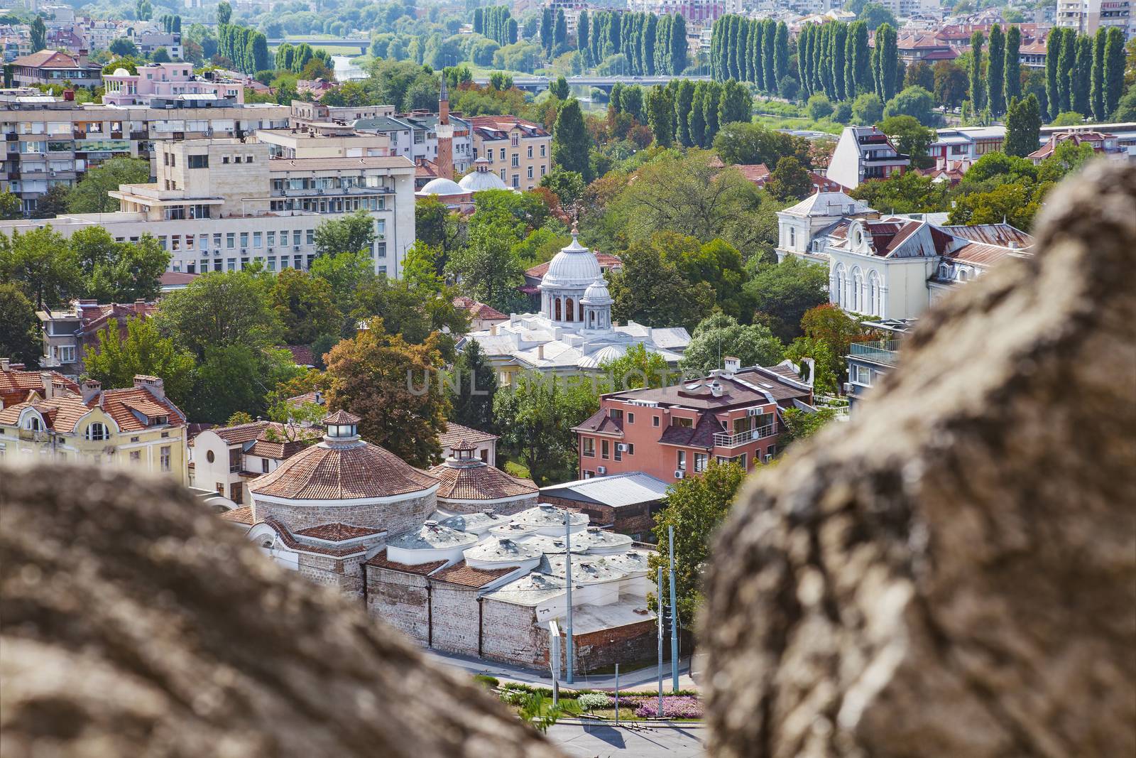 View of Plovdiv, Bulgaria downtown with old and new buildings and trees along Maritsa river.