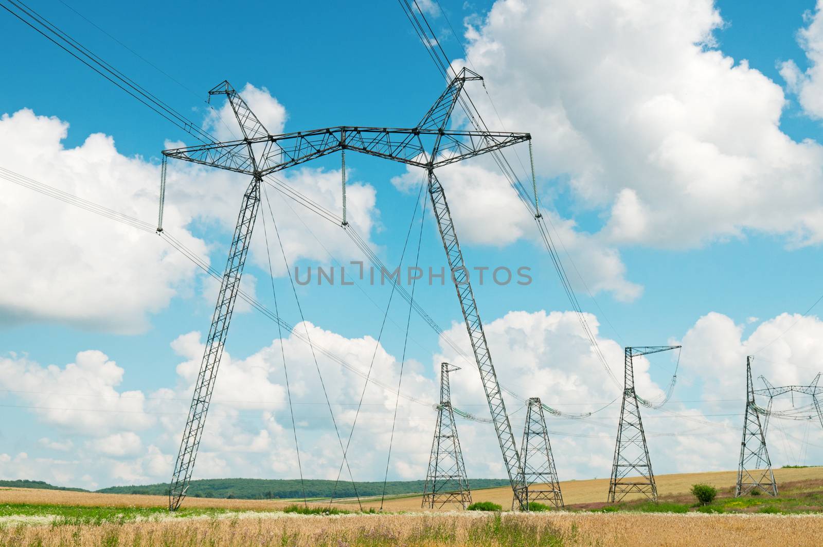 Power transmission line on a background of the cloudy sky