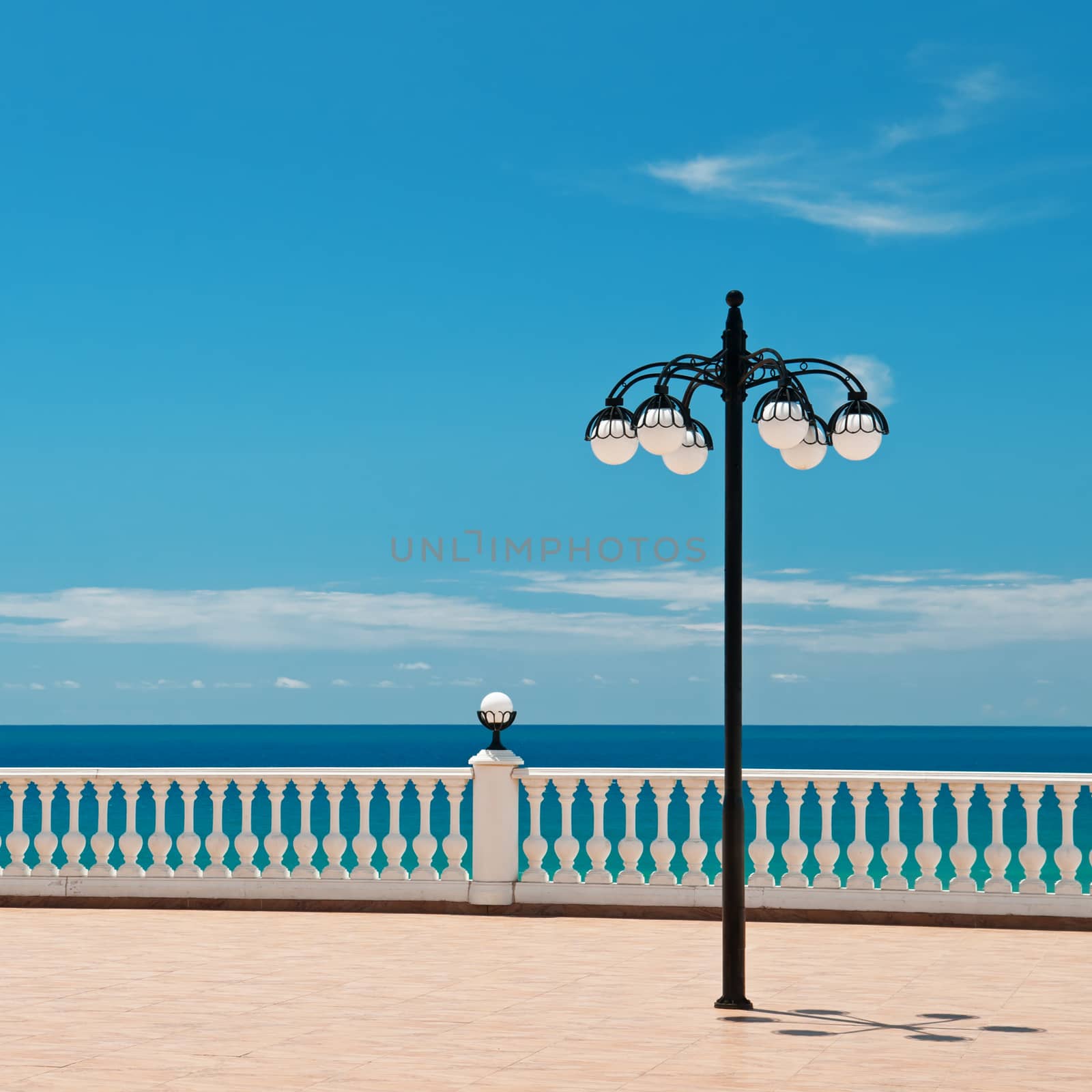 beautiful promenade with lanterns and white railings