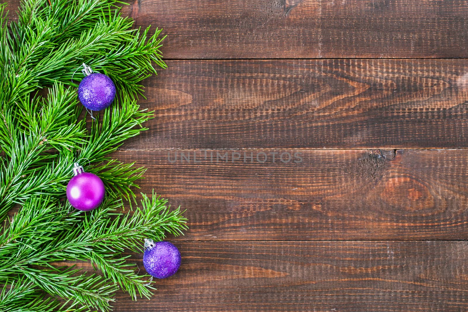 Christmas fir tree with decoration on wooden background by fascinadora