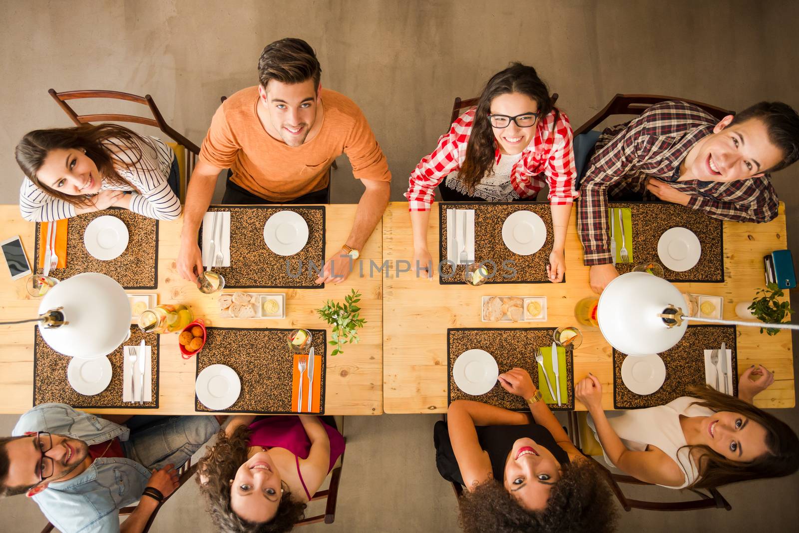 Group of people toasting and looking happy at a restaurant