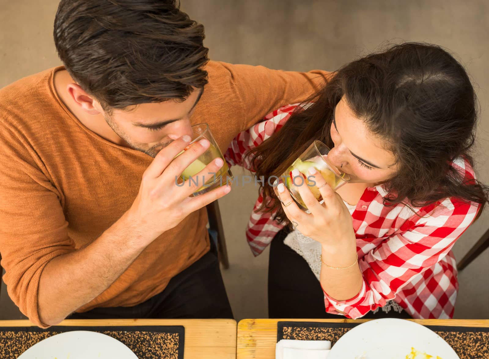 Young couple at a restaurant drinking and having a good time 