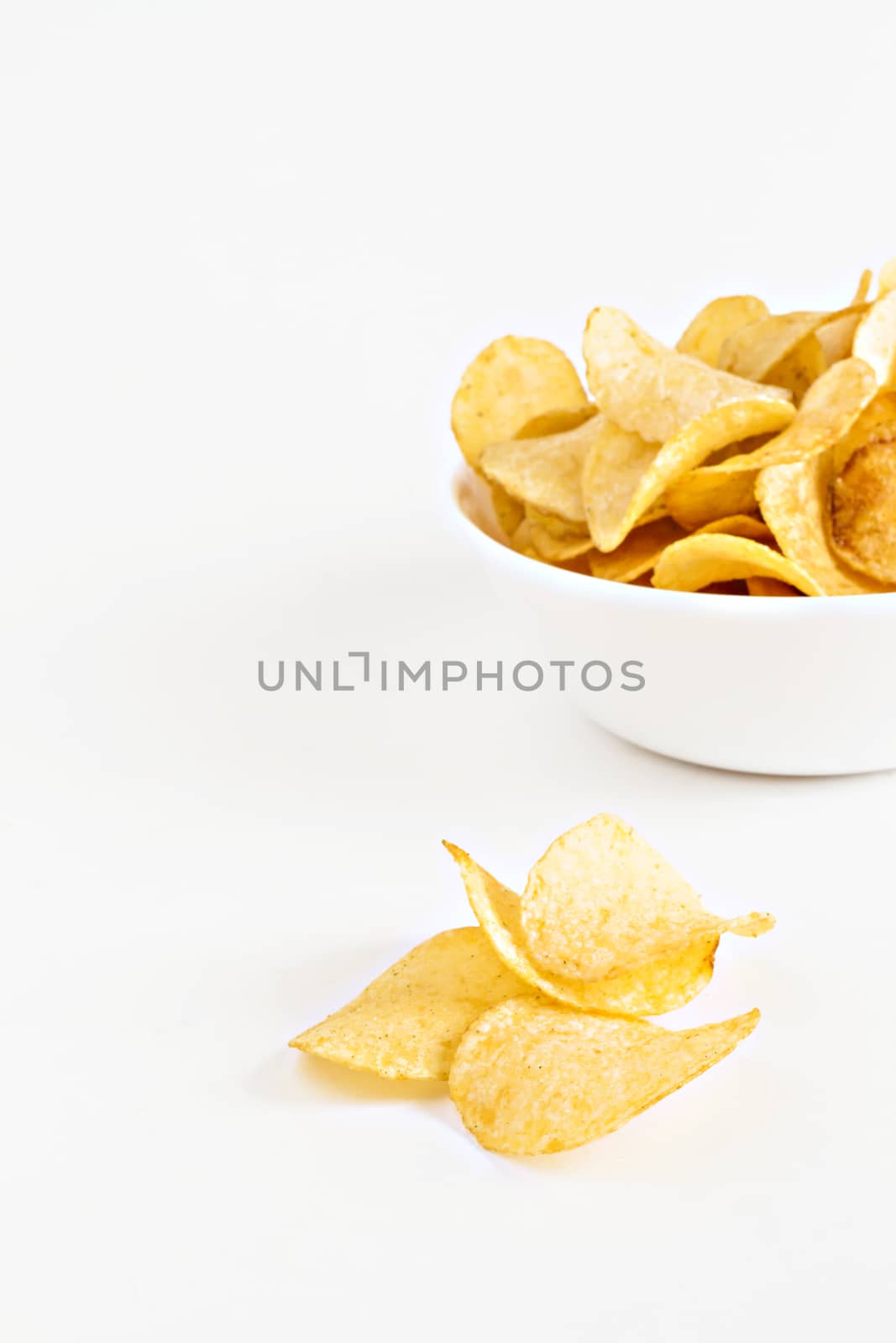 potato chips in a white dish isolated.