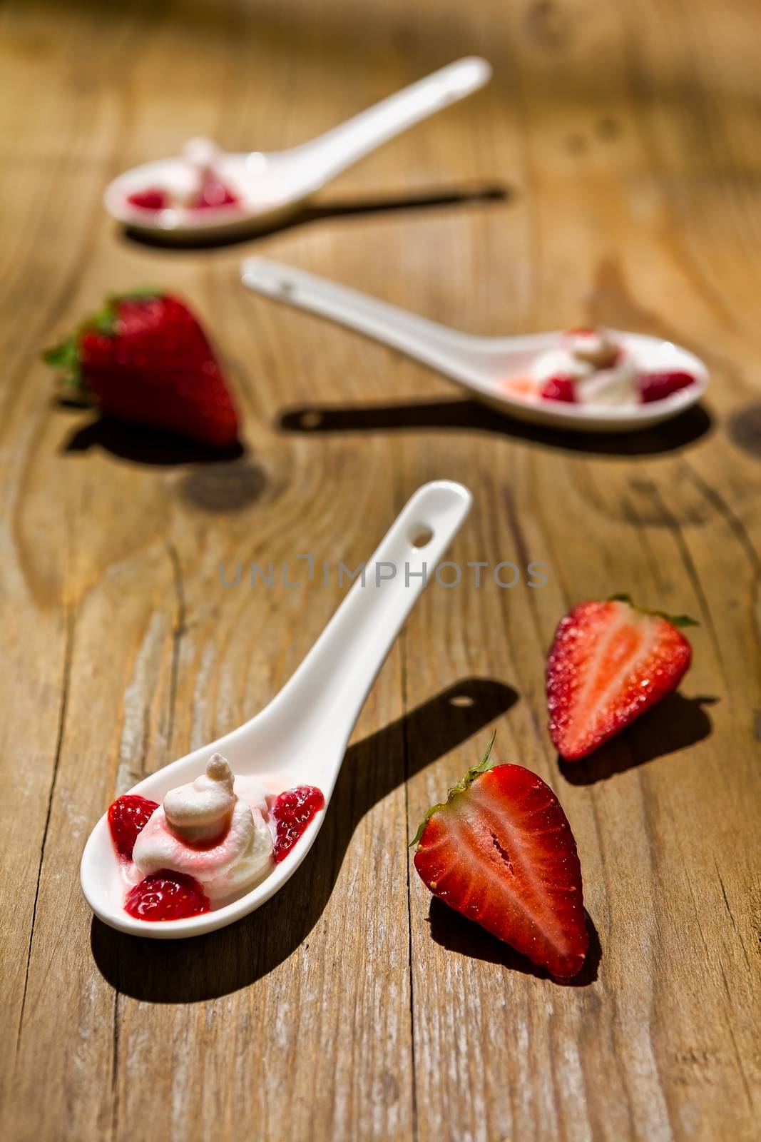 Mascarpone cheese and strawberries on wooden background