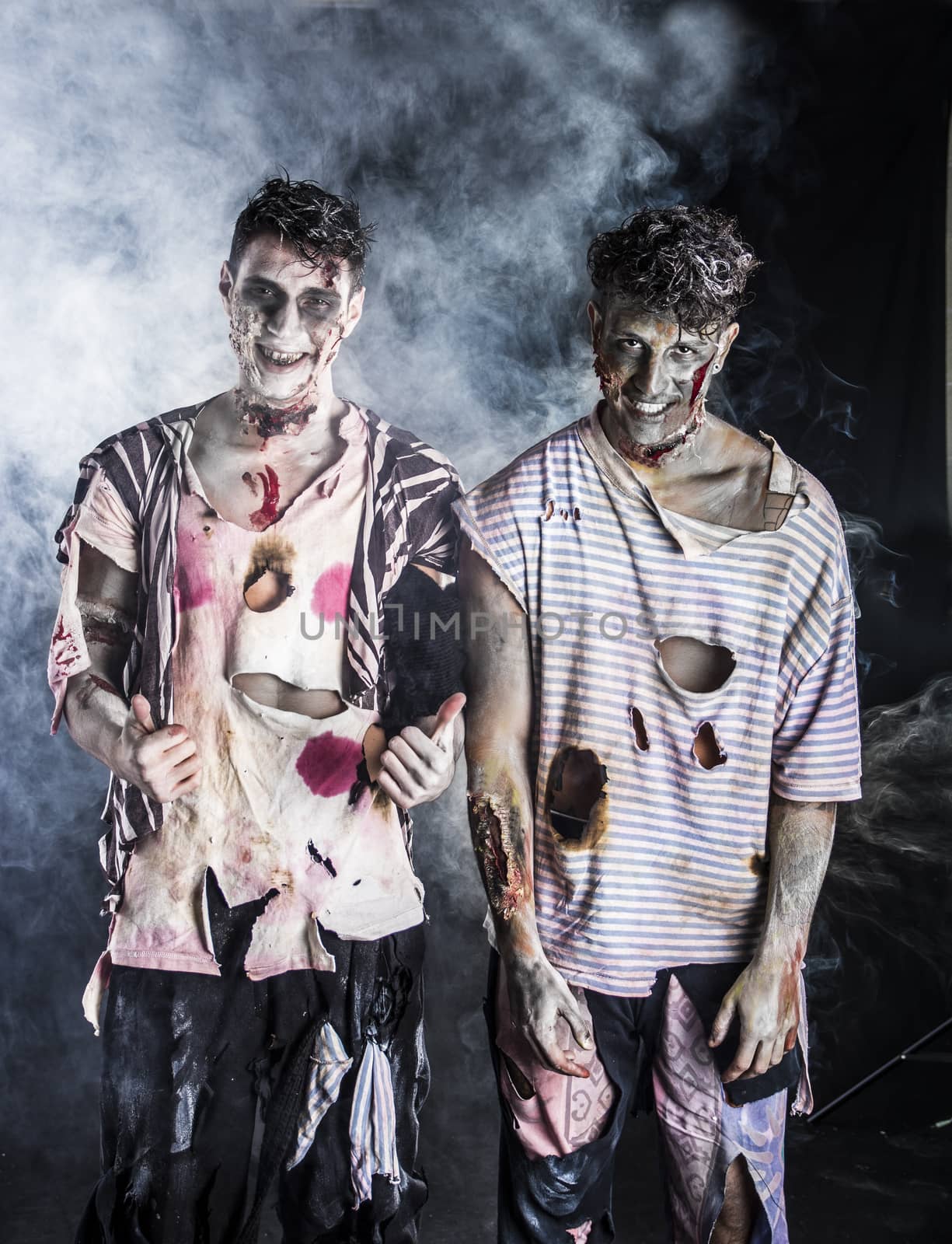 Two male zombies standing on black smoky background by artofphoto
