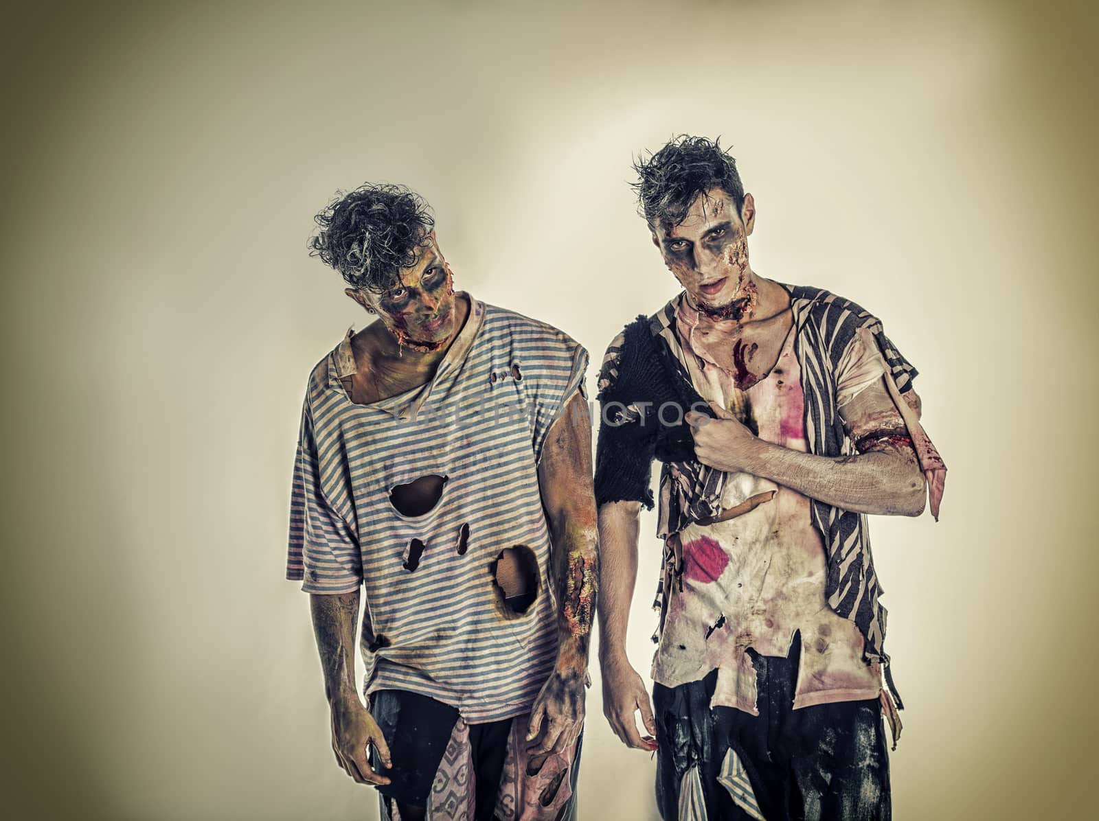 Two male zombies standing on black smoky background, head and shoulder shot