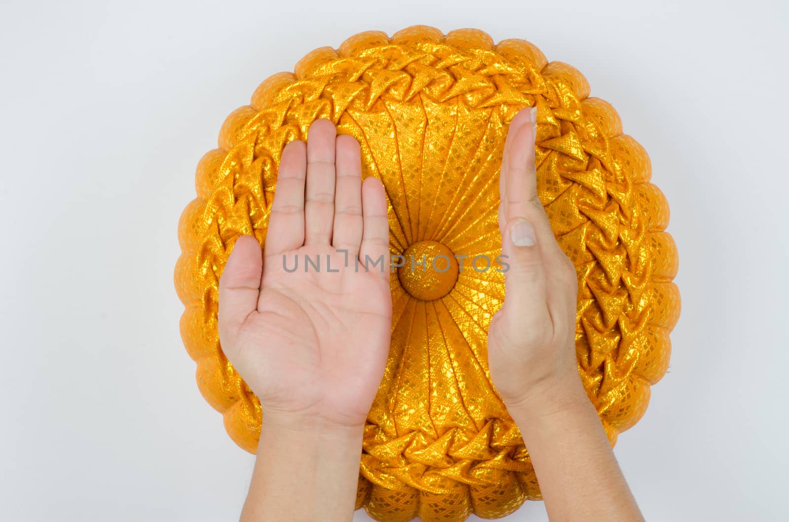 Thai silk Pumkin Pillow and hand on white background