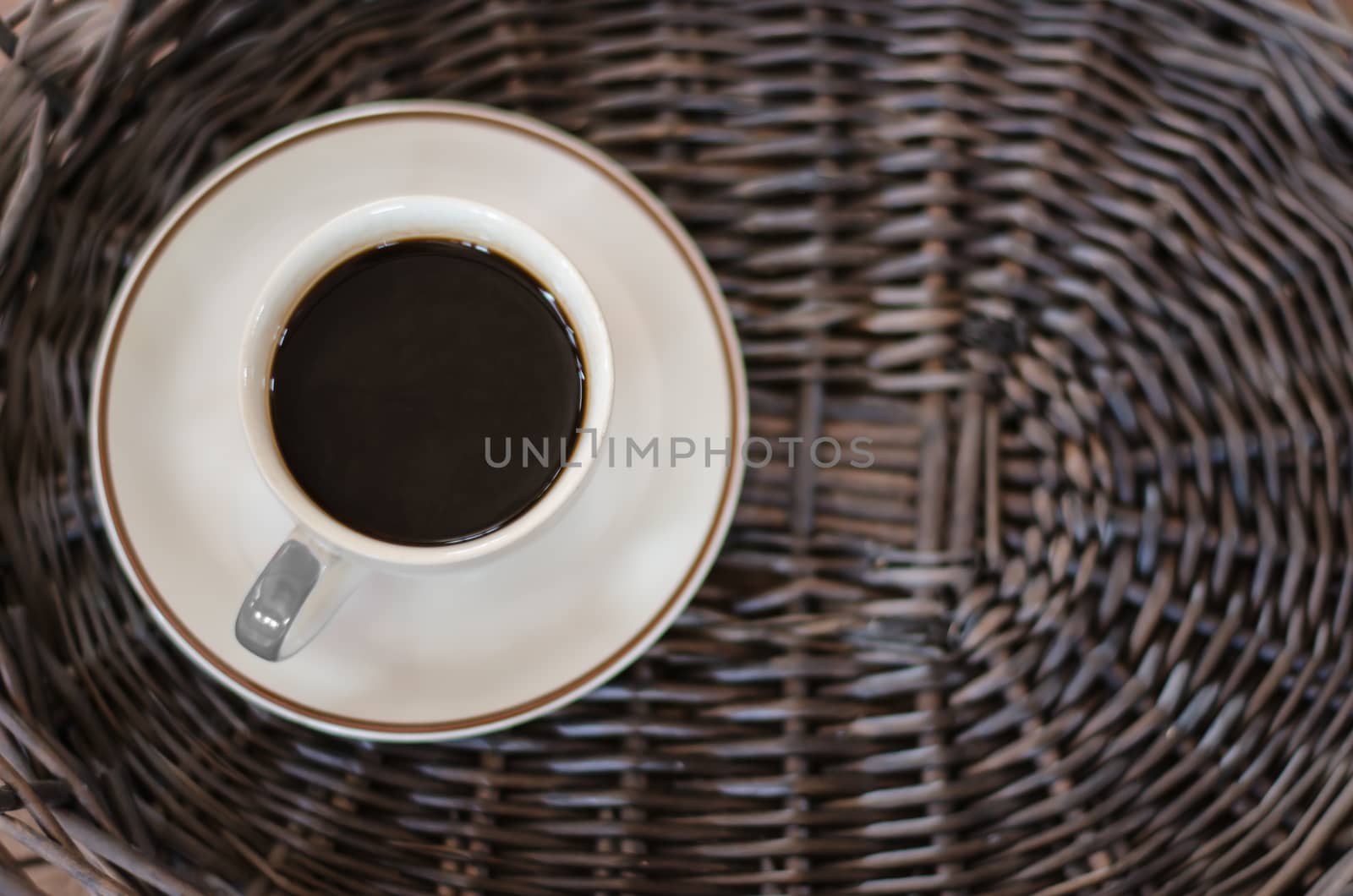 Cup of hot coffee on wicker baskets by metal22