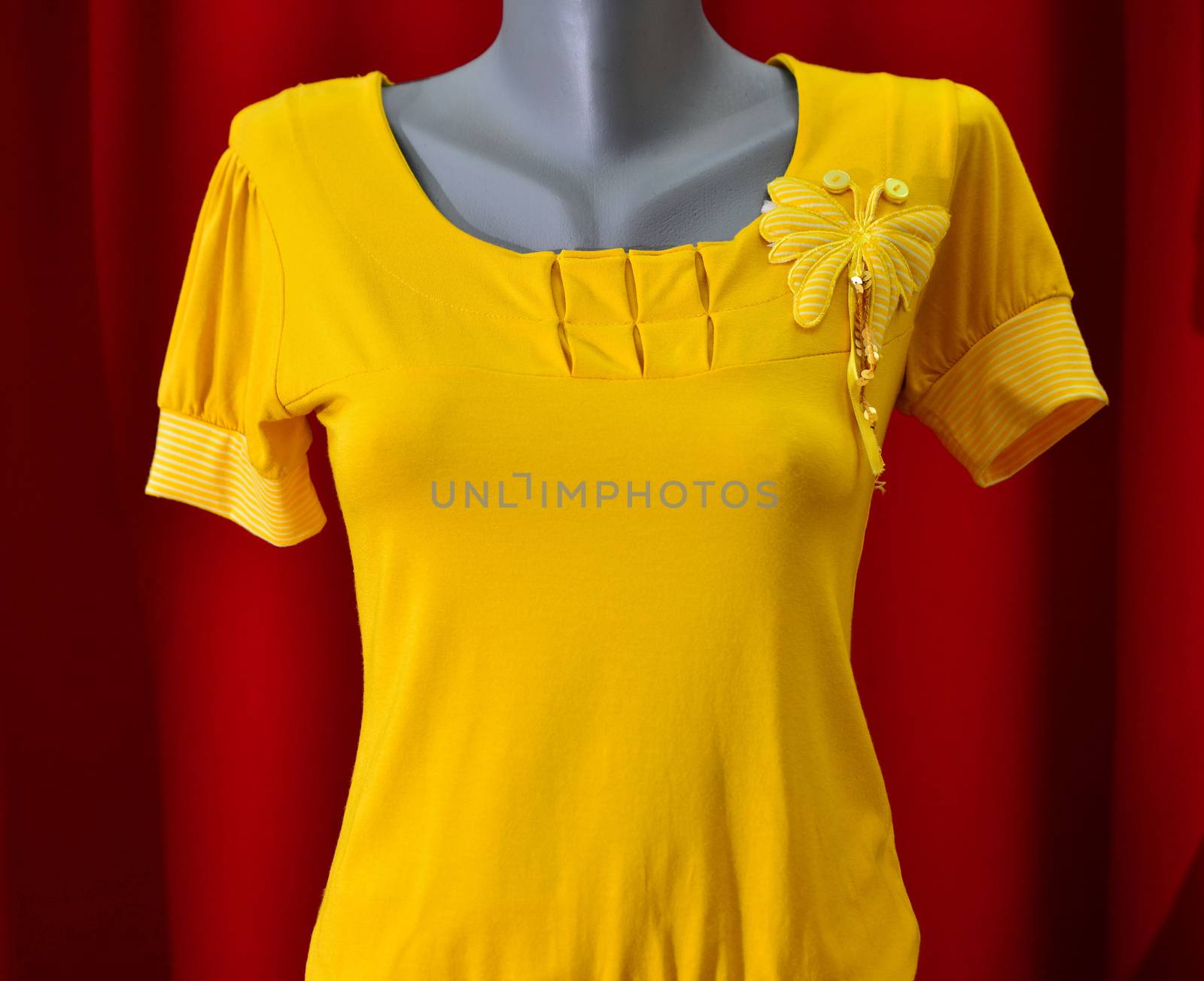 picture of a fashion summer clothes on a manequin doll on a red background