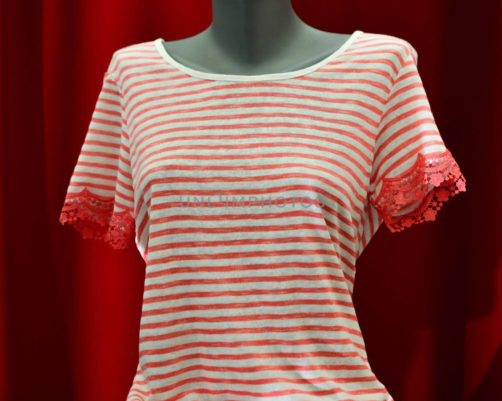 picture of a fashion summer clothes on a manequin doll on a red background