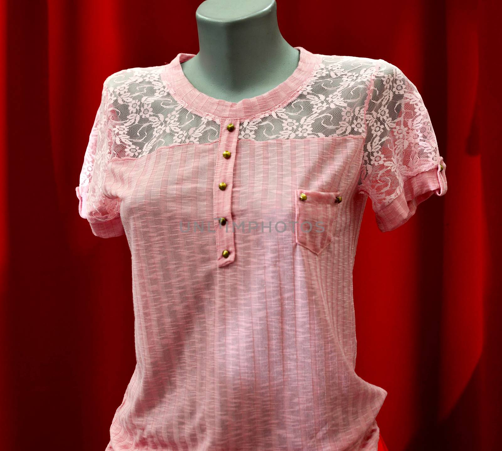 picture of a fashion summer clothes on a manequin doll on a red background