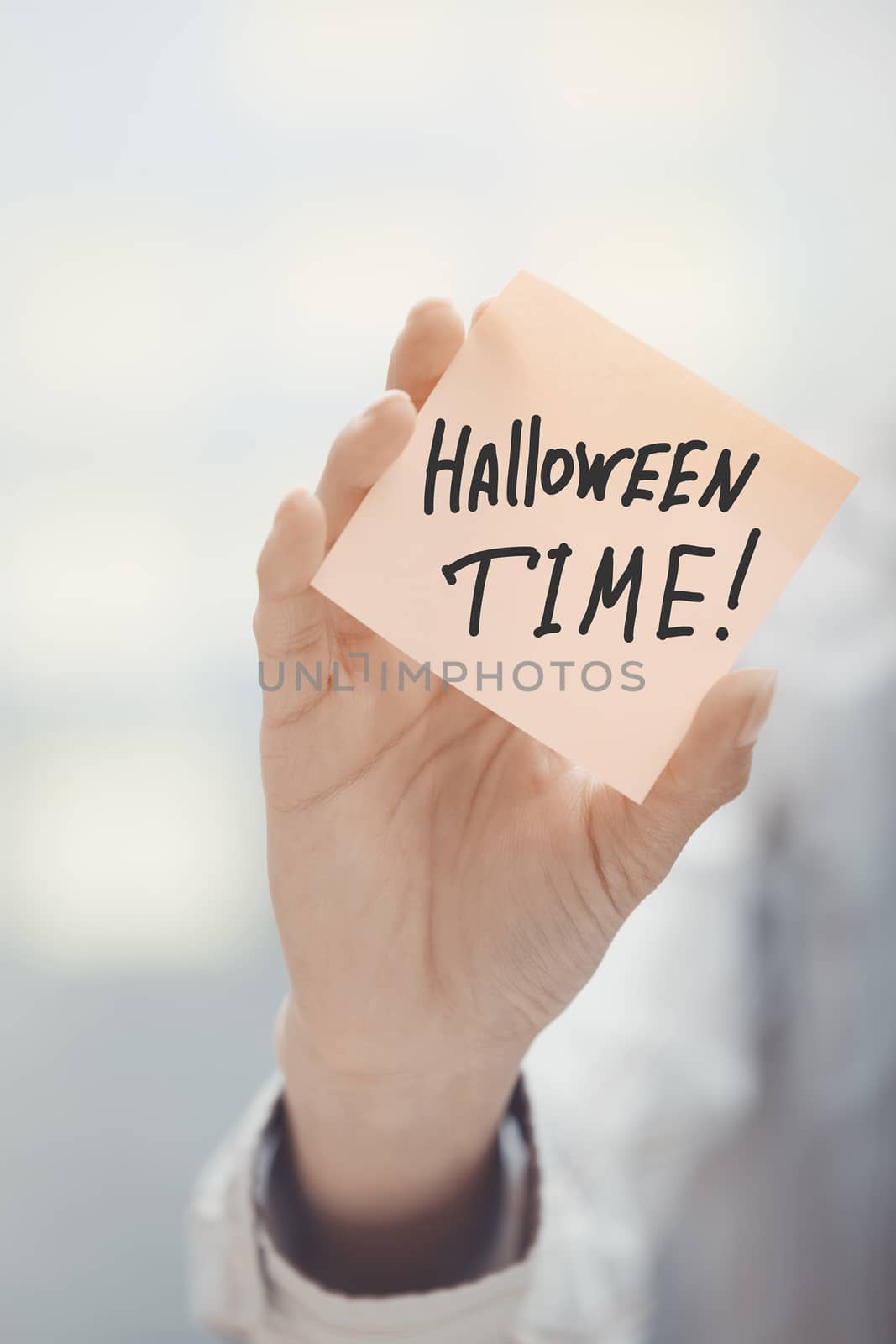 Woman holding agenda with Halloween time text by Novic