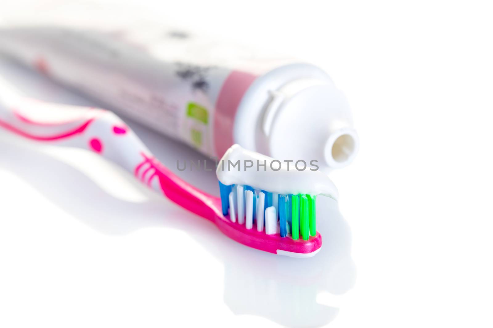 toothbrush with toothpaste close-up on white background