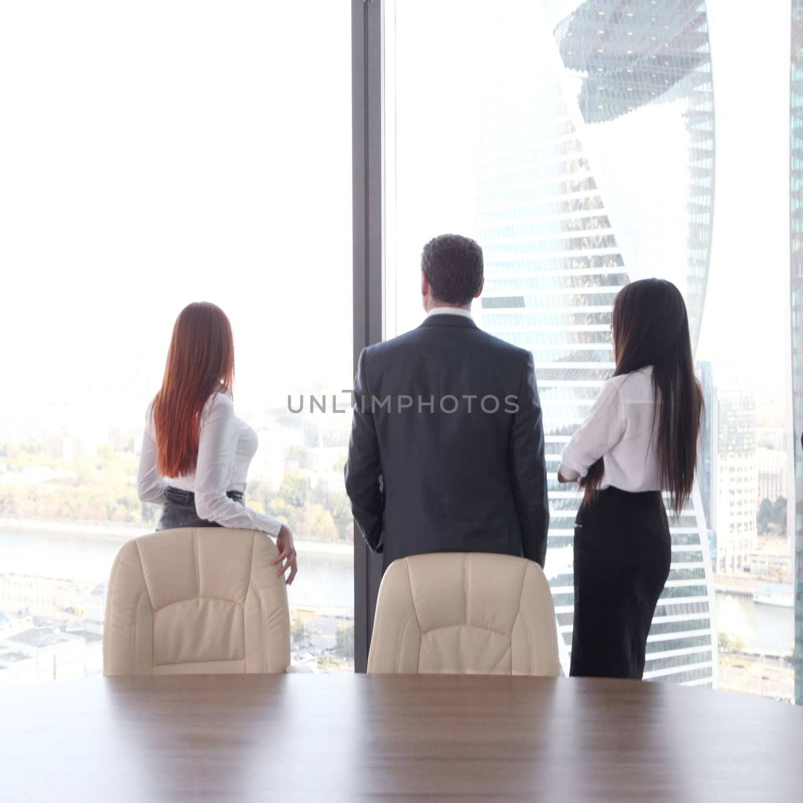 Rear view of business people looking at window