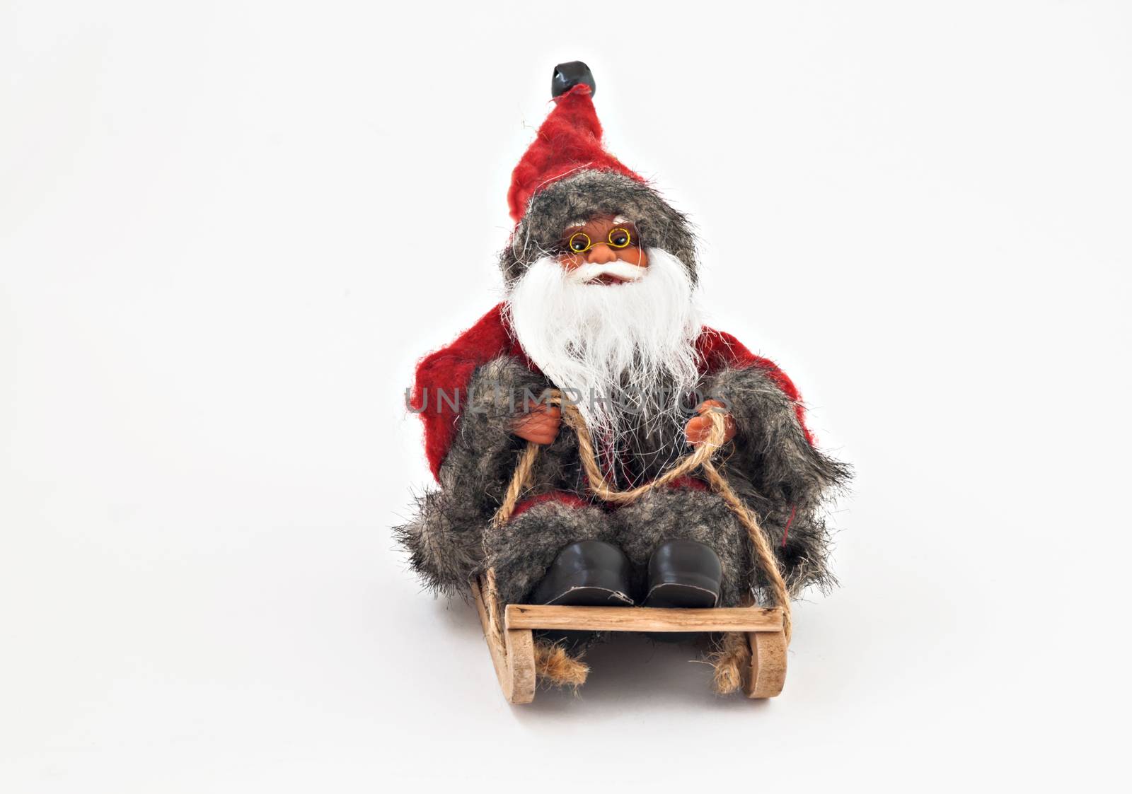 Santa Claus with a beard on a sled tree toy isolated.