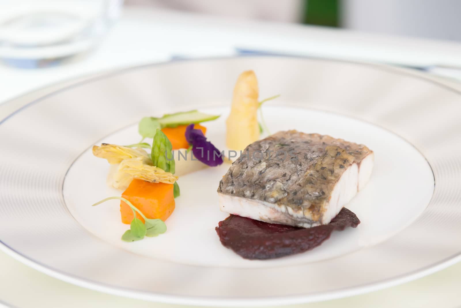 the minimalistic dish fish with vegetables on white plate