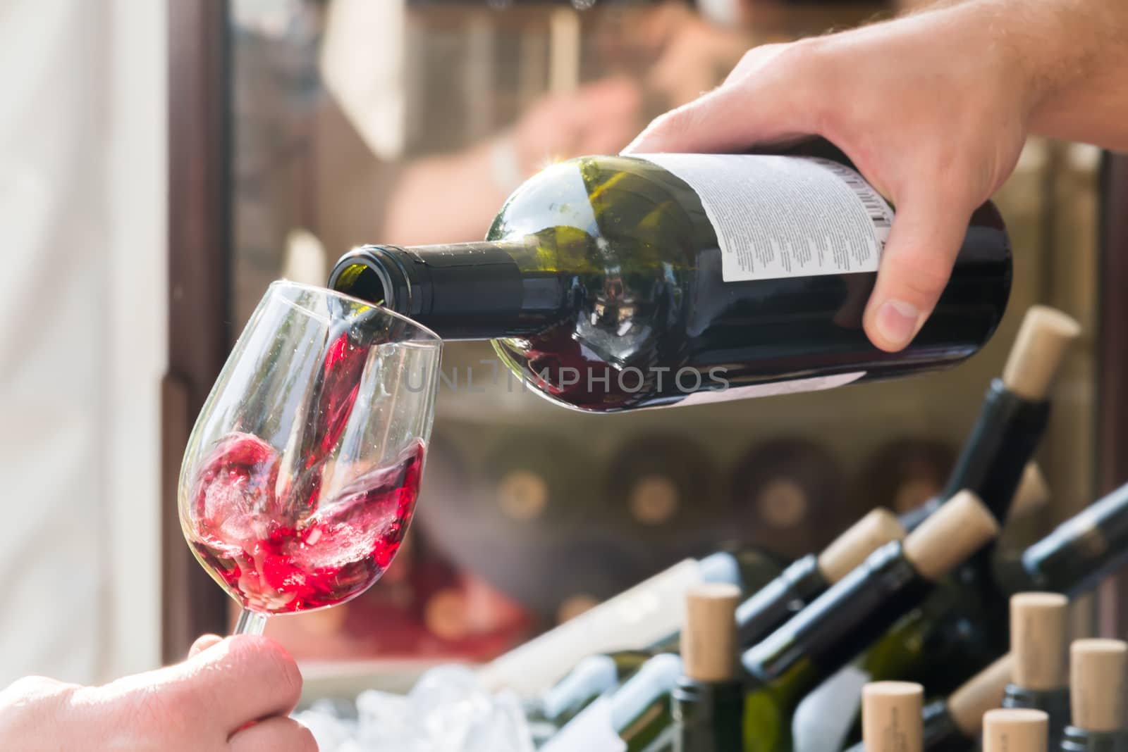 the red wine being poured into a glass close-up