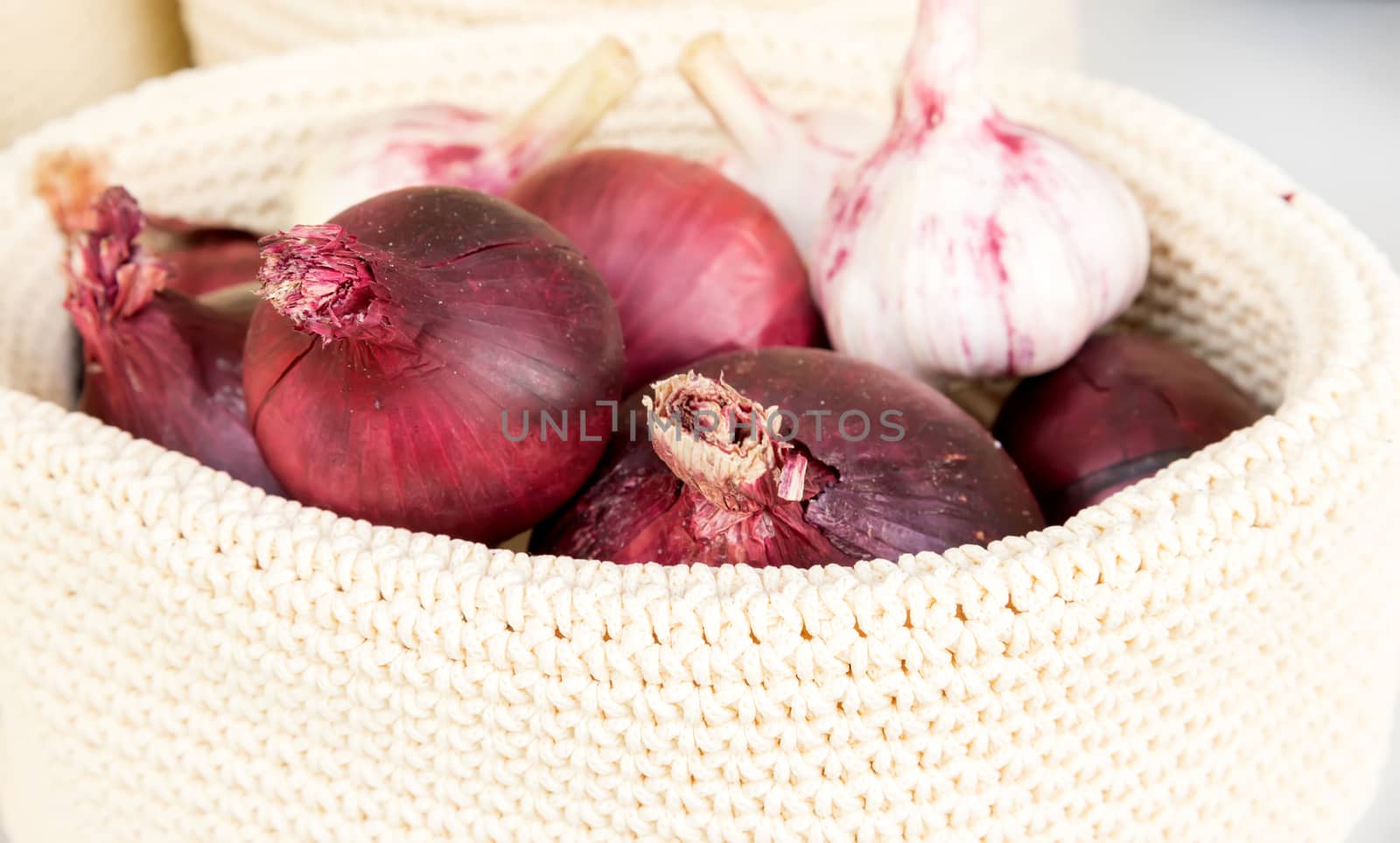 the red onions in a wicker basket close-up