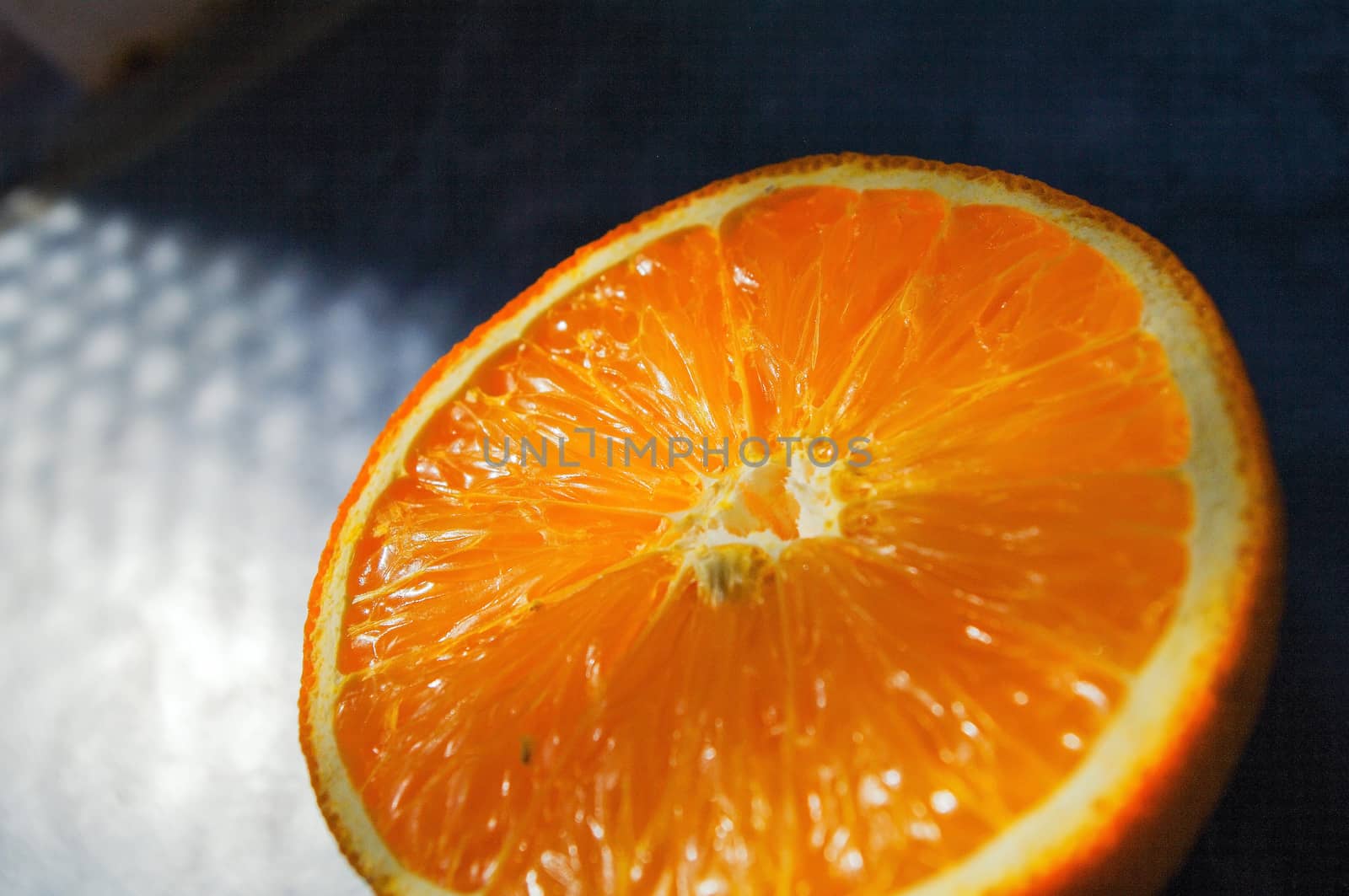 fresh orange halved in closeup, oranges cut in half by evolutionnow